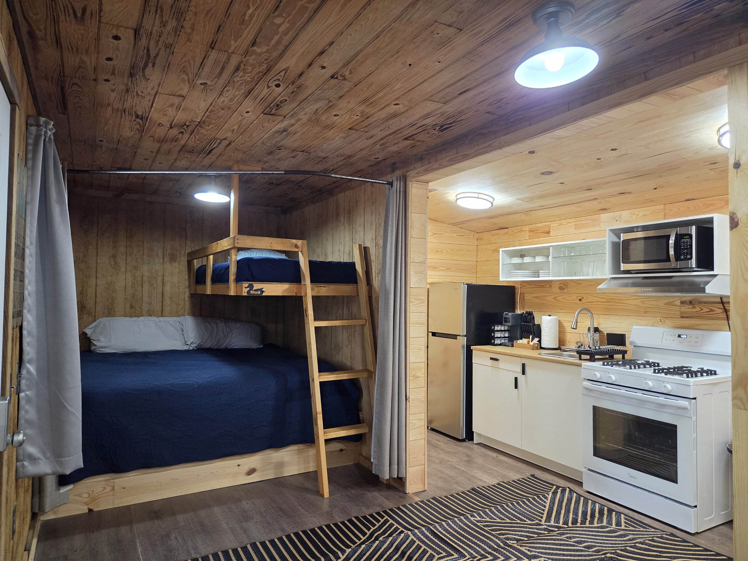 Newly remodeled Coyote Den cabin, showing beds, kitchen, & bathroom addition. 