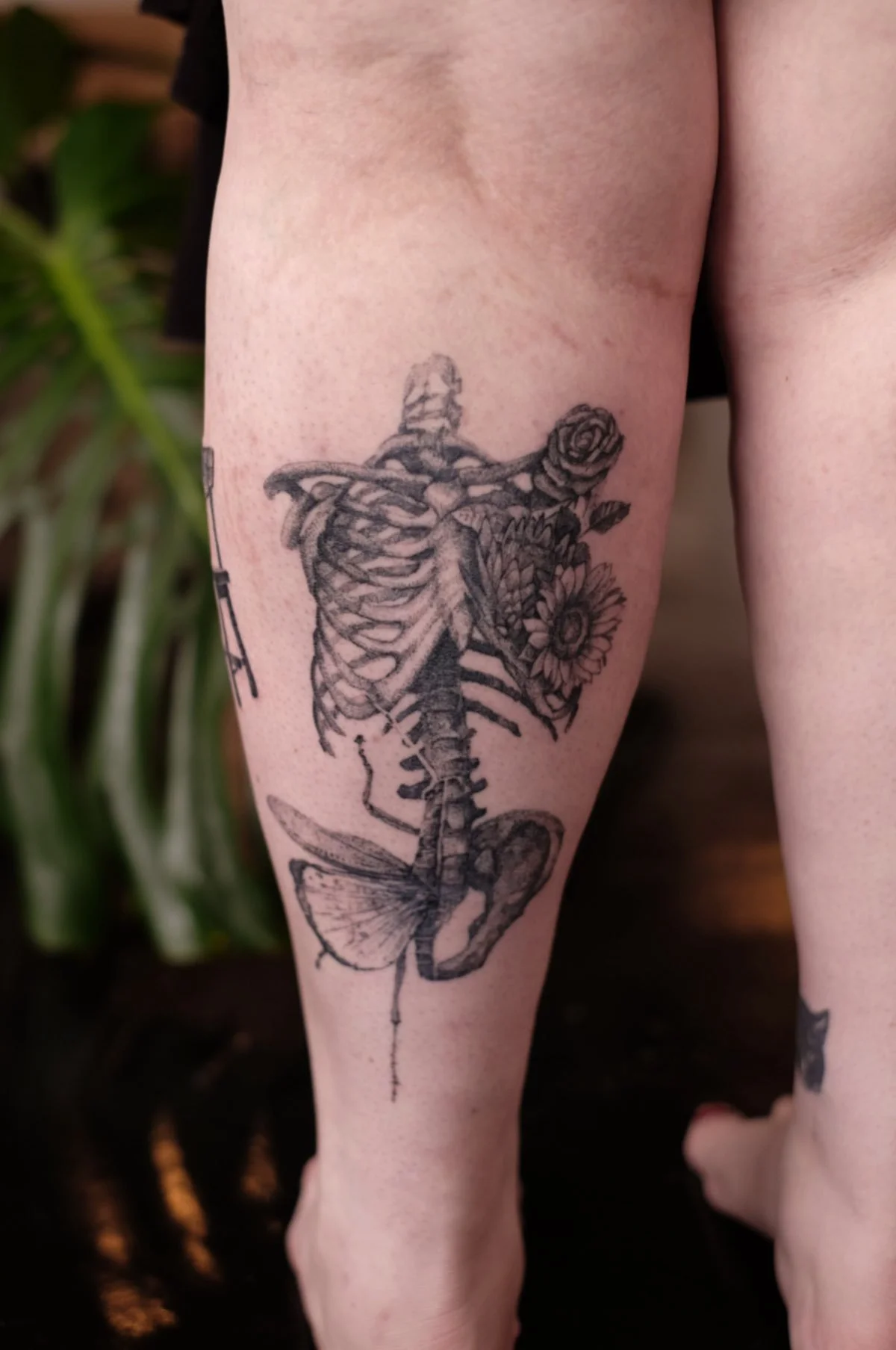 Dotwork skeleton combined with flowers and grasshopper tattooed by Jak