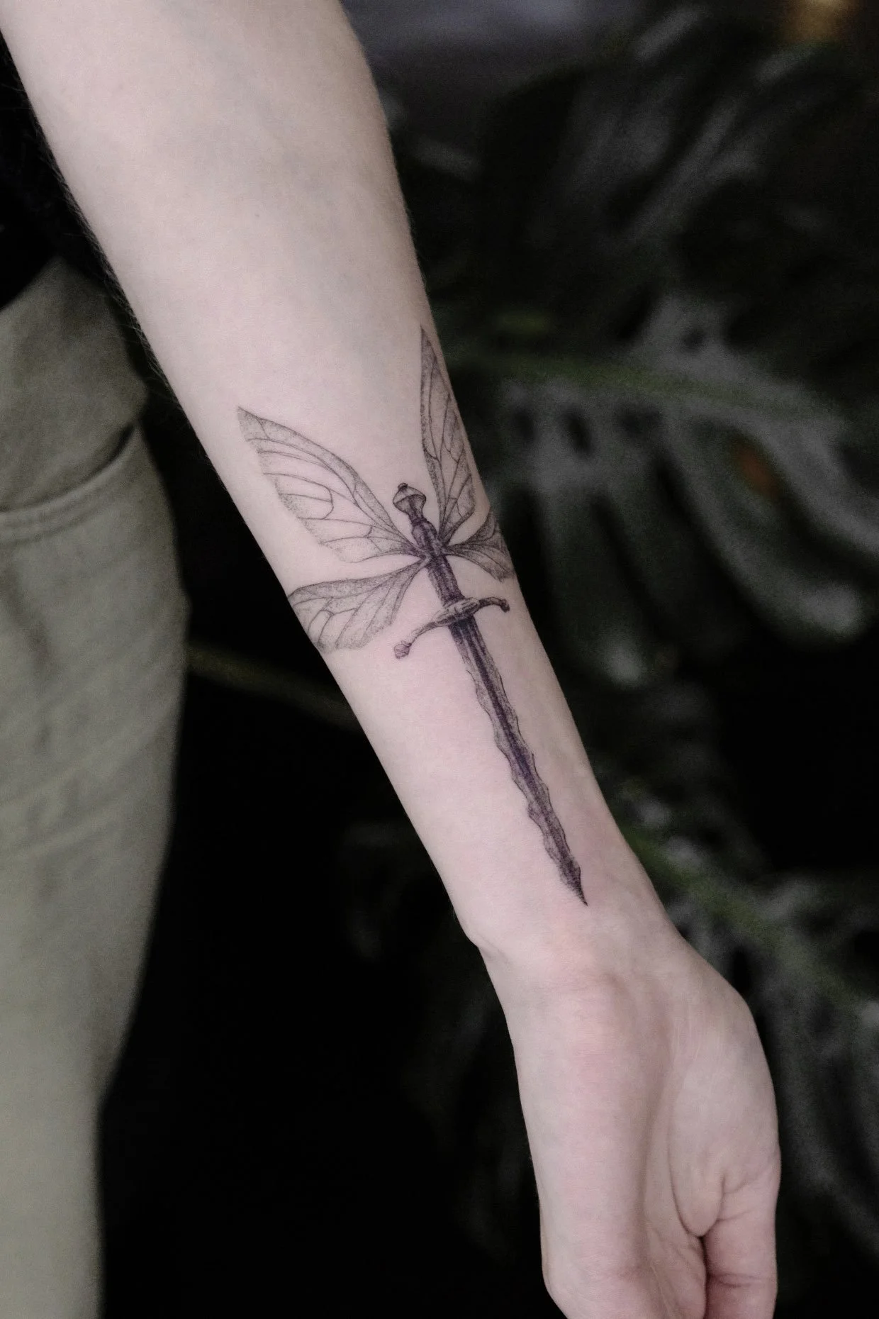 Fine Line tattoo of a dragonfly with detailed wings on a person's forearm by Jak
