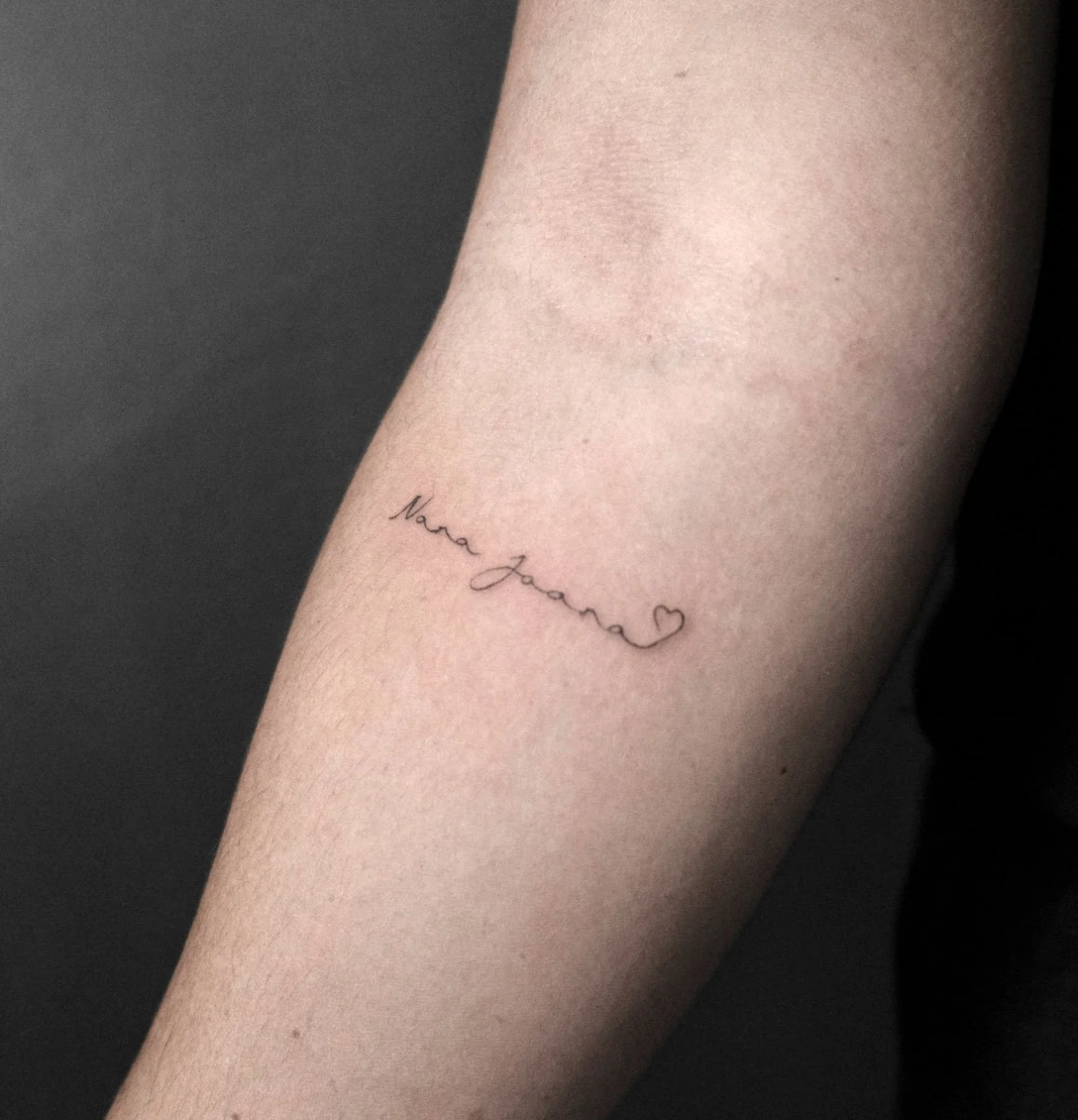 Fine line text on the forearm tattooed by Jak