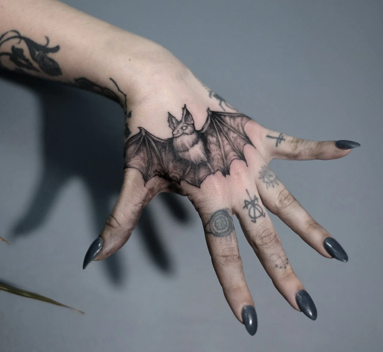 Fine Line tattoo of a bat on the hand by Jak