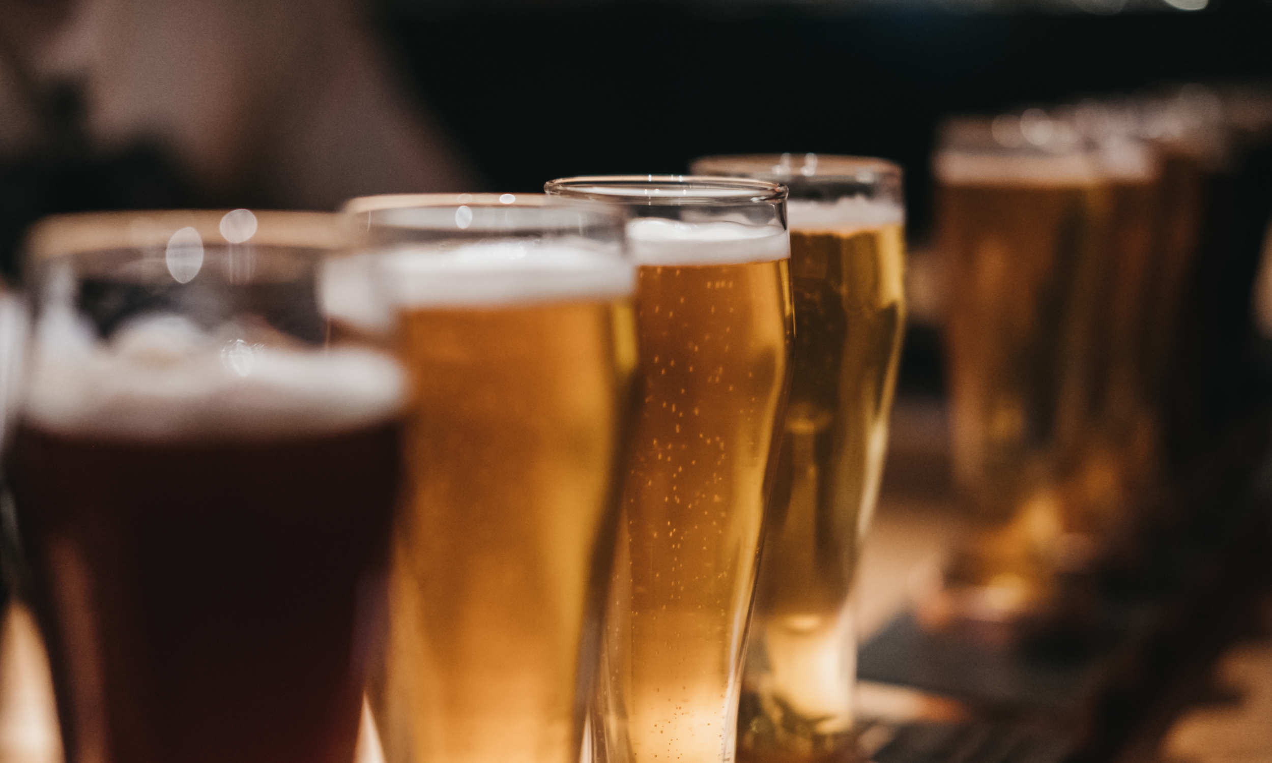 Four beer glasses in a row
