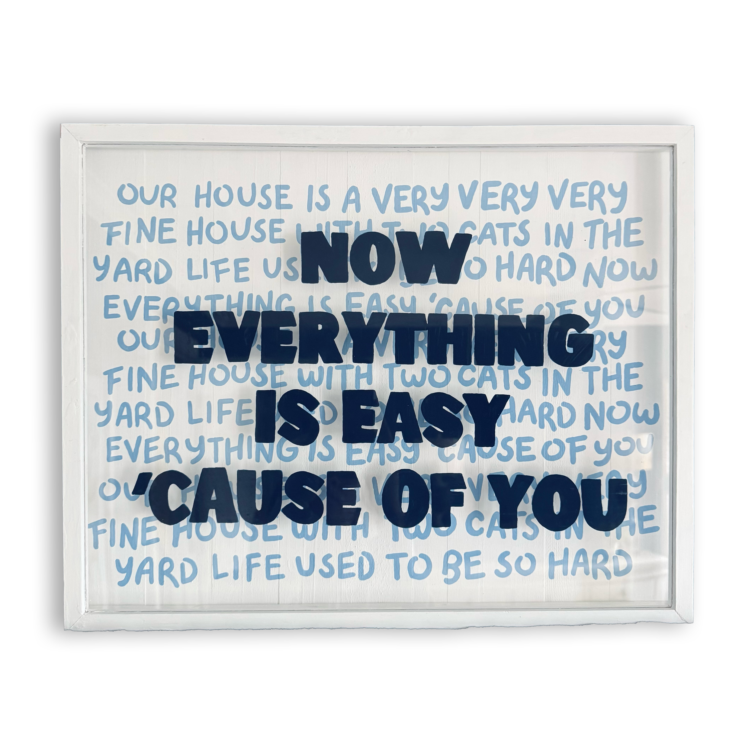 White framed notice board with handwritten blue text and large dark blue letters that say, 'NOW EVERYTHING IS EASY'.