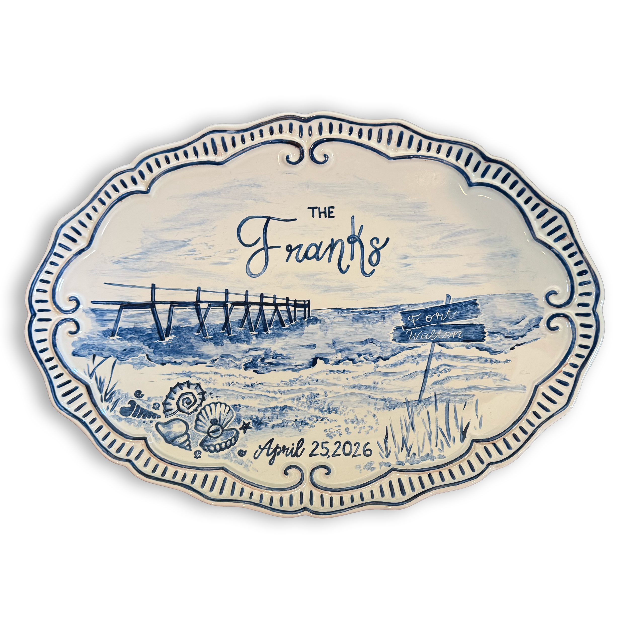 Decorative ceramic plate with blue hand-painted designs and the text 'The Framps' and the date 'April 25, 2026.'