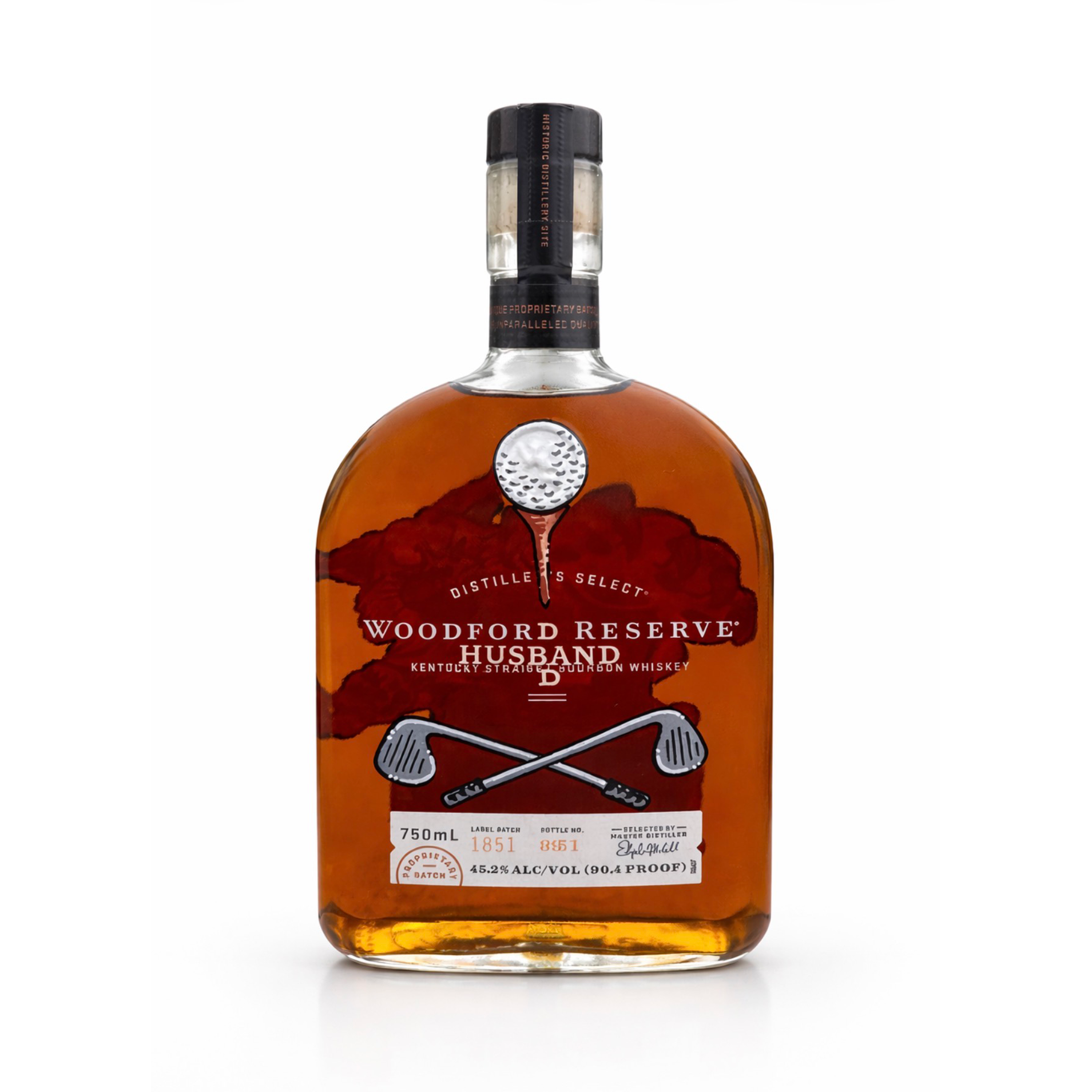 A bottle of Woodford Reserve Bourbon whiskey with a label featuring crossed golf clubs and red leaves, set against a plain white background.