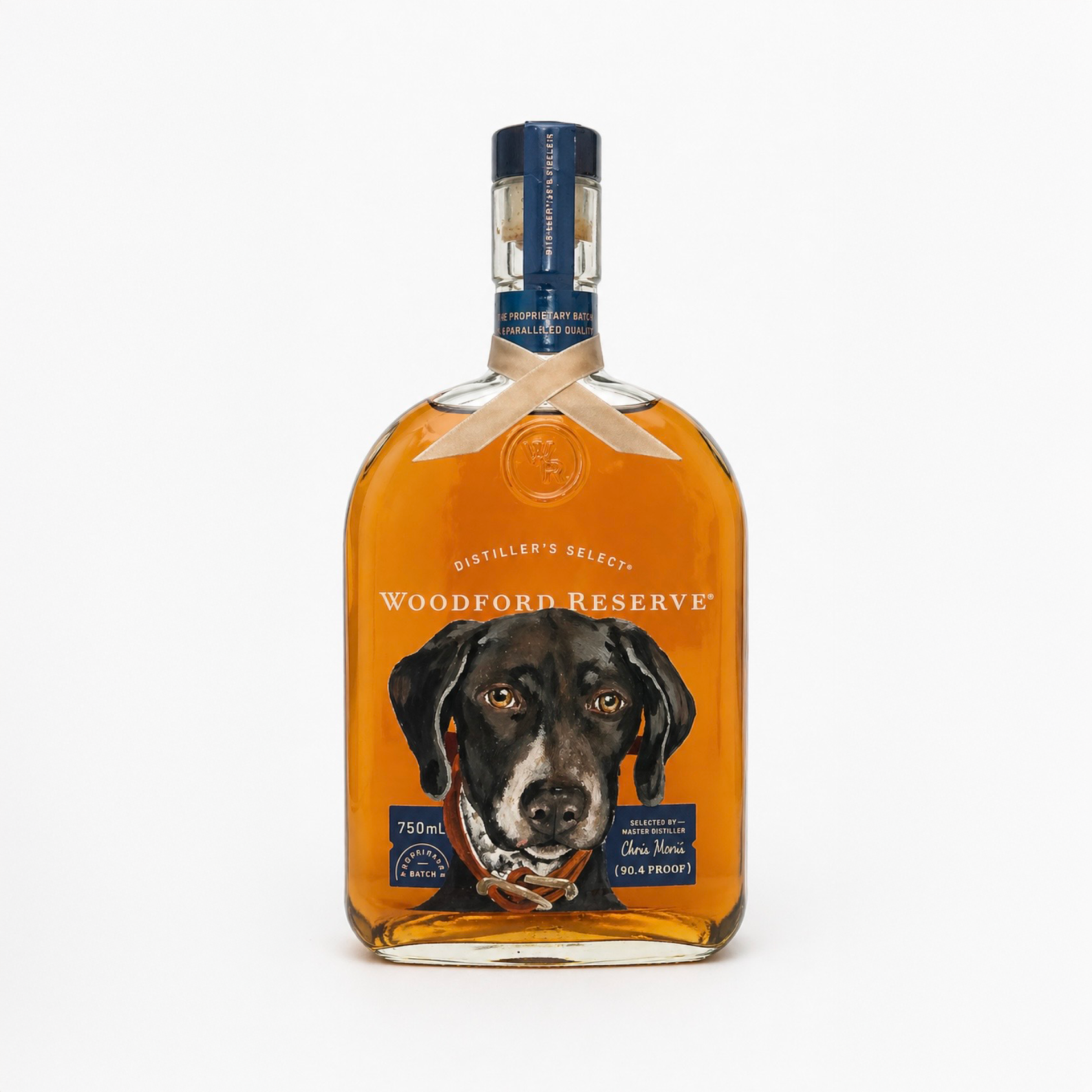 A bottle of Woodford Reserve bourbon whiskey with a label featuring a dog's portrait, against a plain white background.