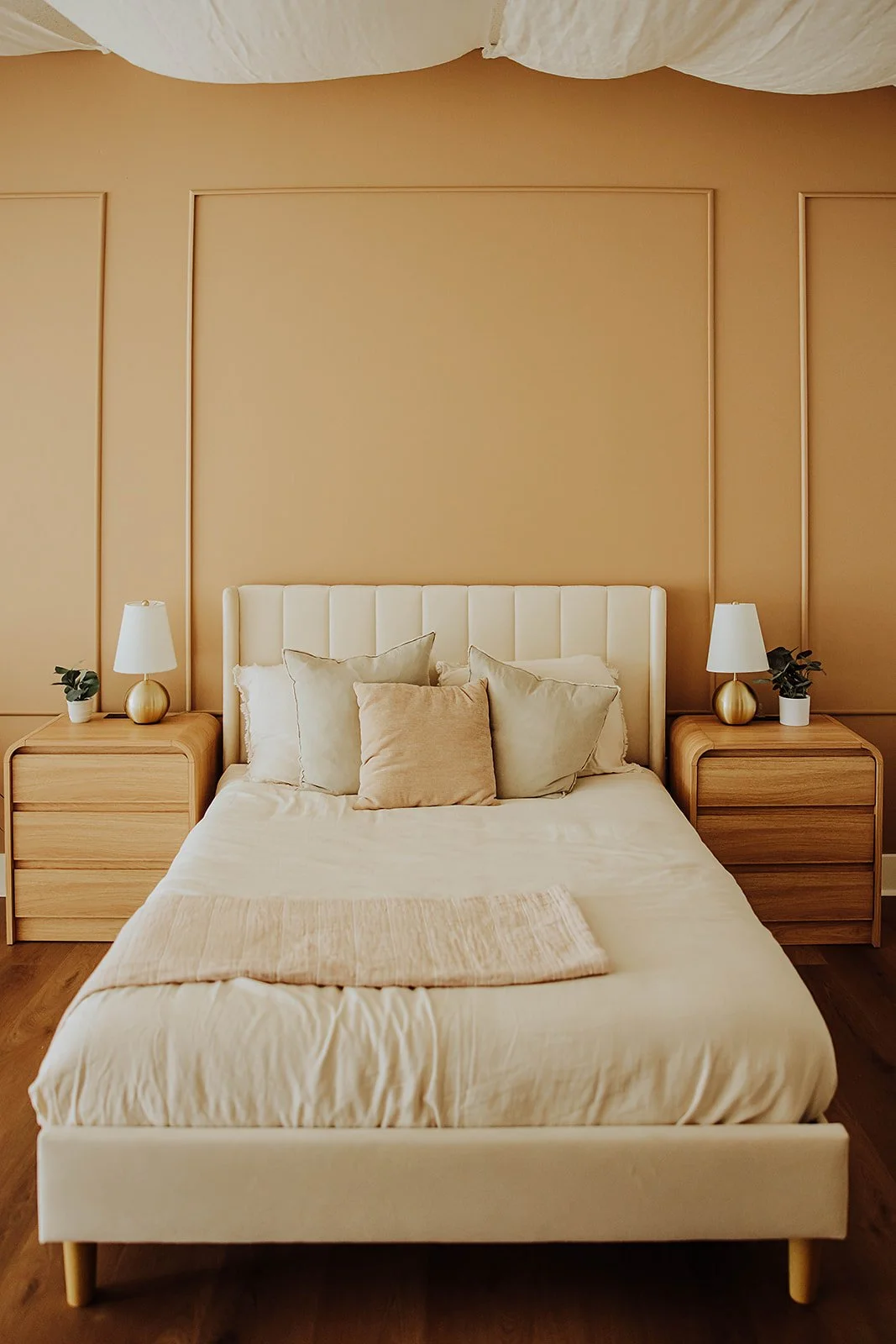 Styled bedroom set with upholstered bed and nightstands at The ANS Collective photo studio