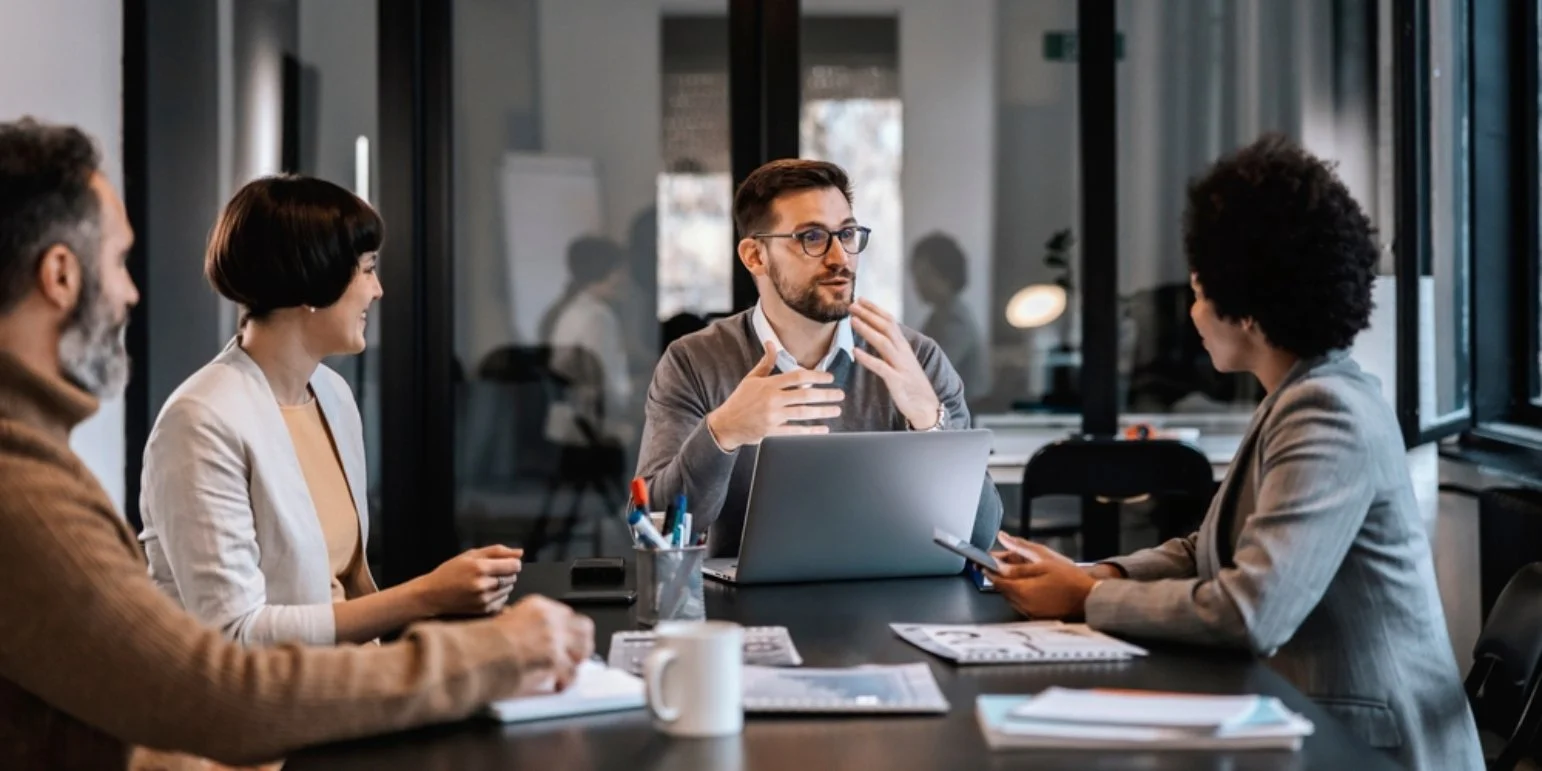 People talking around a board table