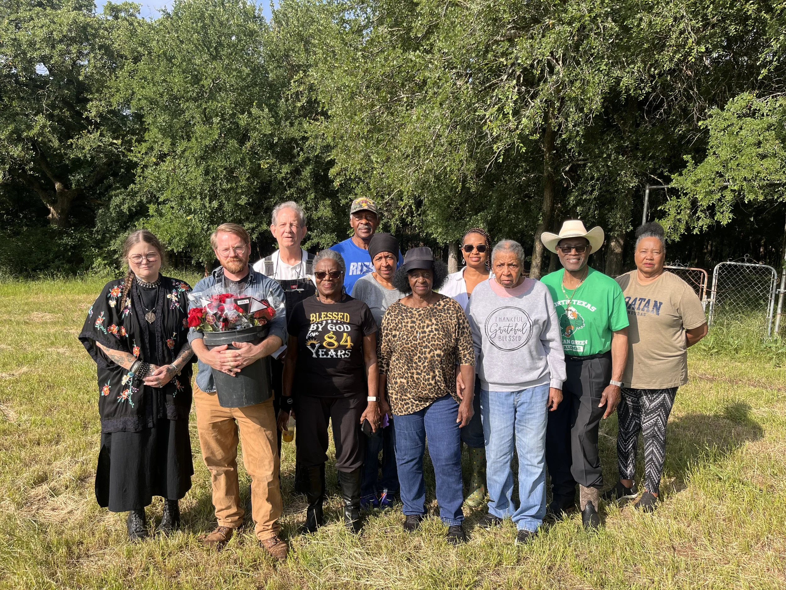SJCA Members stand together outside St Johns Cemetery