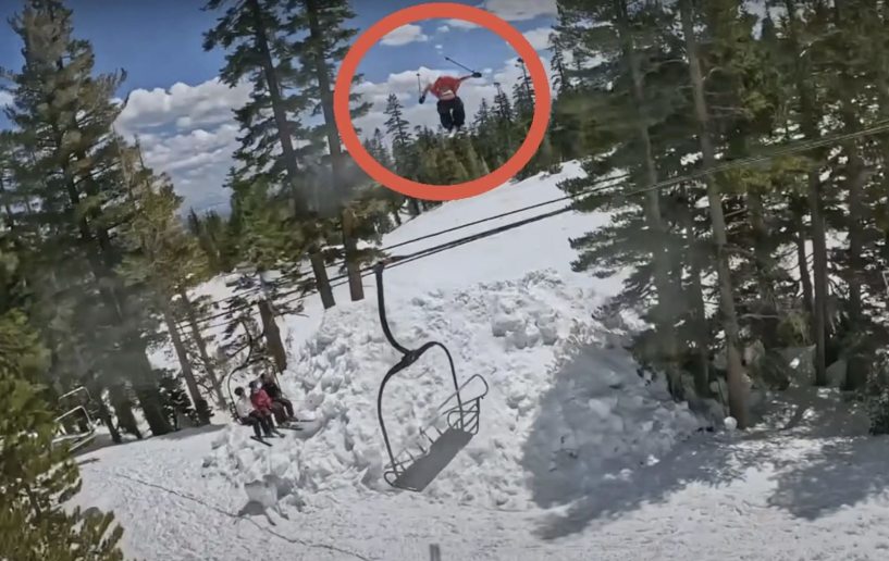 Person falling backwards from a ski lift after losing balance while skiing in a snowy forested area.