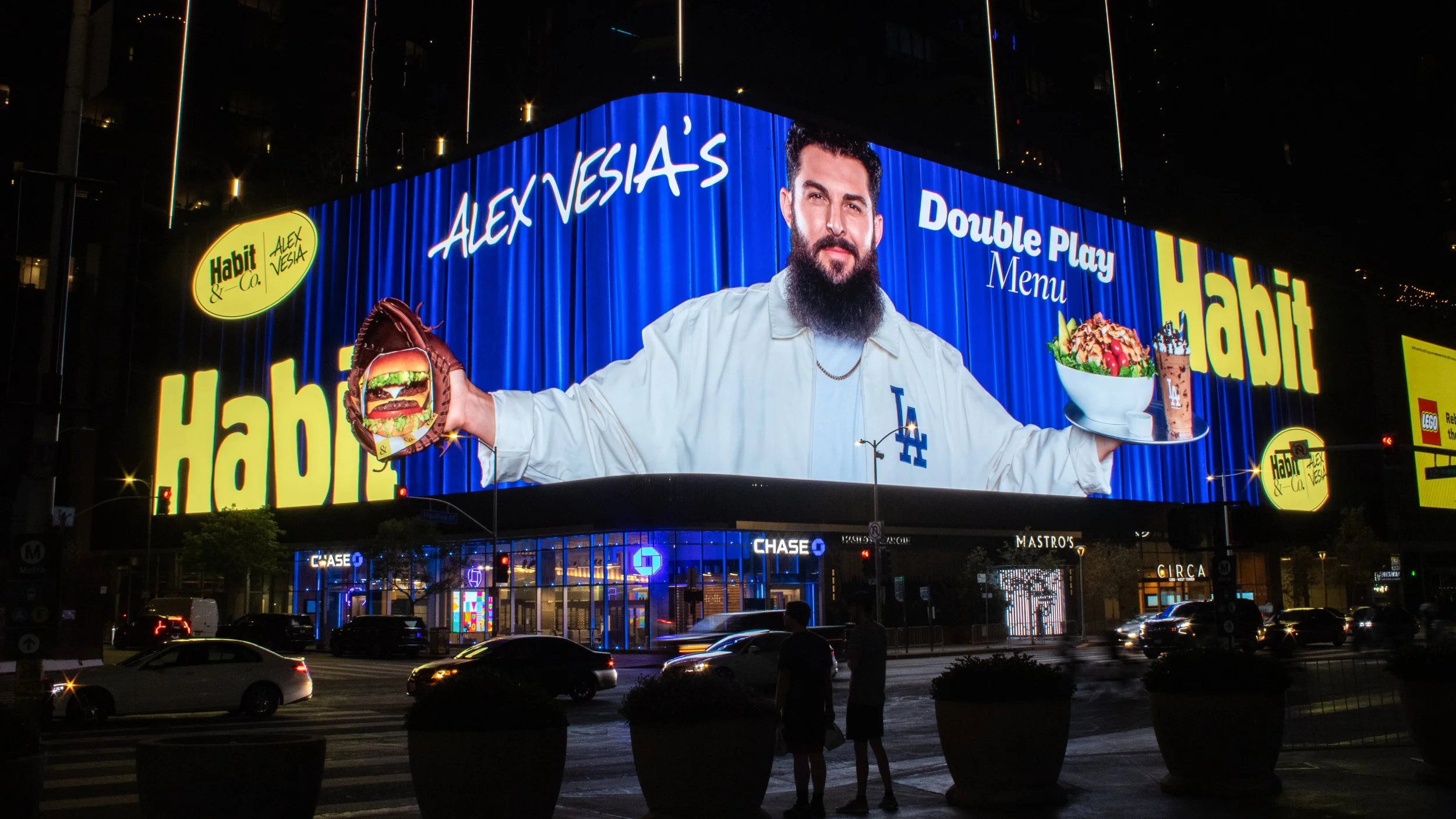 Billboard featuring Alex Vesia with text promoting a double play menu at Habit & Co, including images of a hamburger, salad, and dessert.