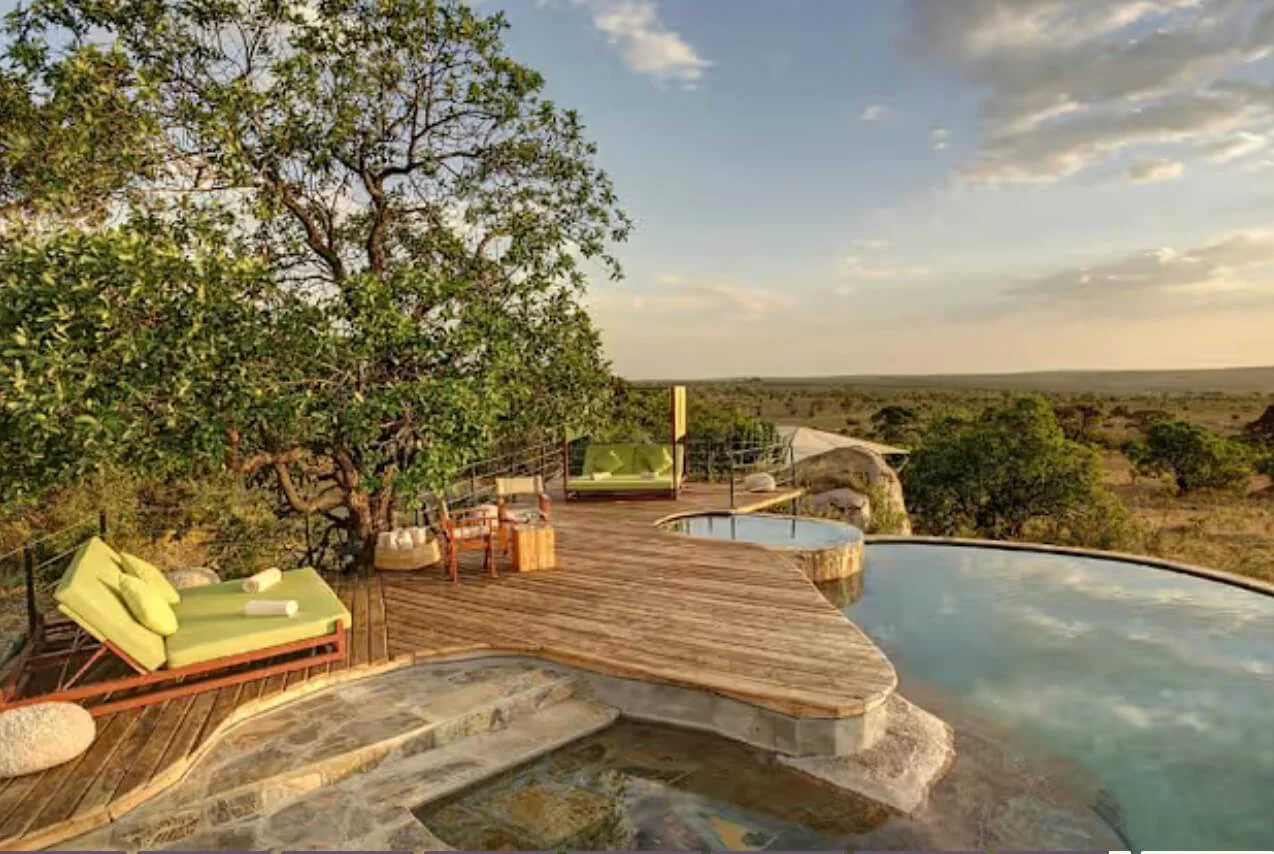 A private luxury balcony with a sunken pool overlooking the Serengeti savanna; an intentional milestone discovery curated by Willow & Wander Travel.