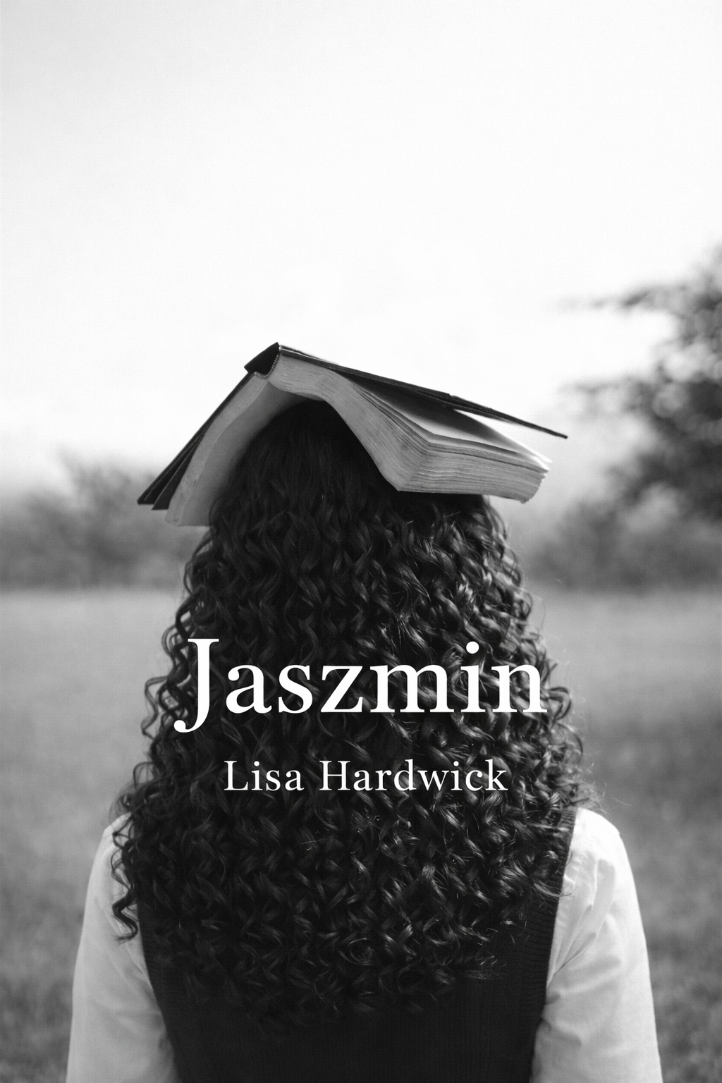 A woman with curly hair stands outdoors with an open book on her head, facing away from the camera, in black and white.