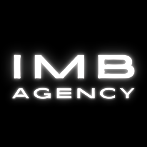 Neon sign displaying 'IMB AGENCY' in white letters on a black background.