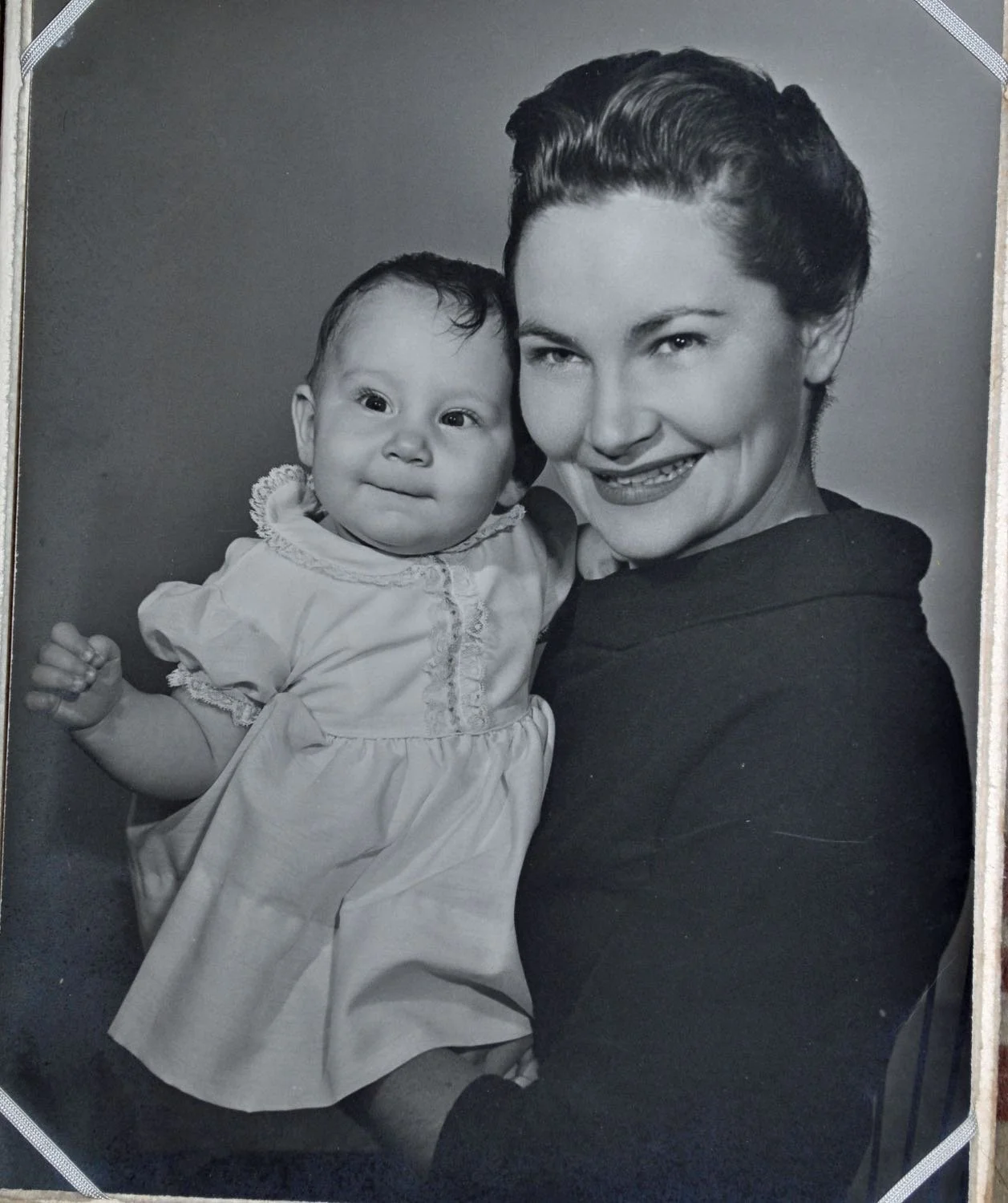 Portrait of one year old Amanda Barusch being held lovingly by her proud mother.