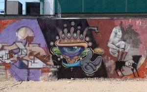 Street Art on a Wellington Street wall featuring an eyeball wearing a crown.