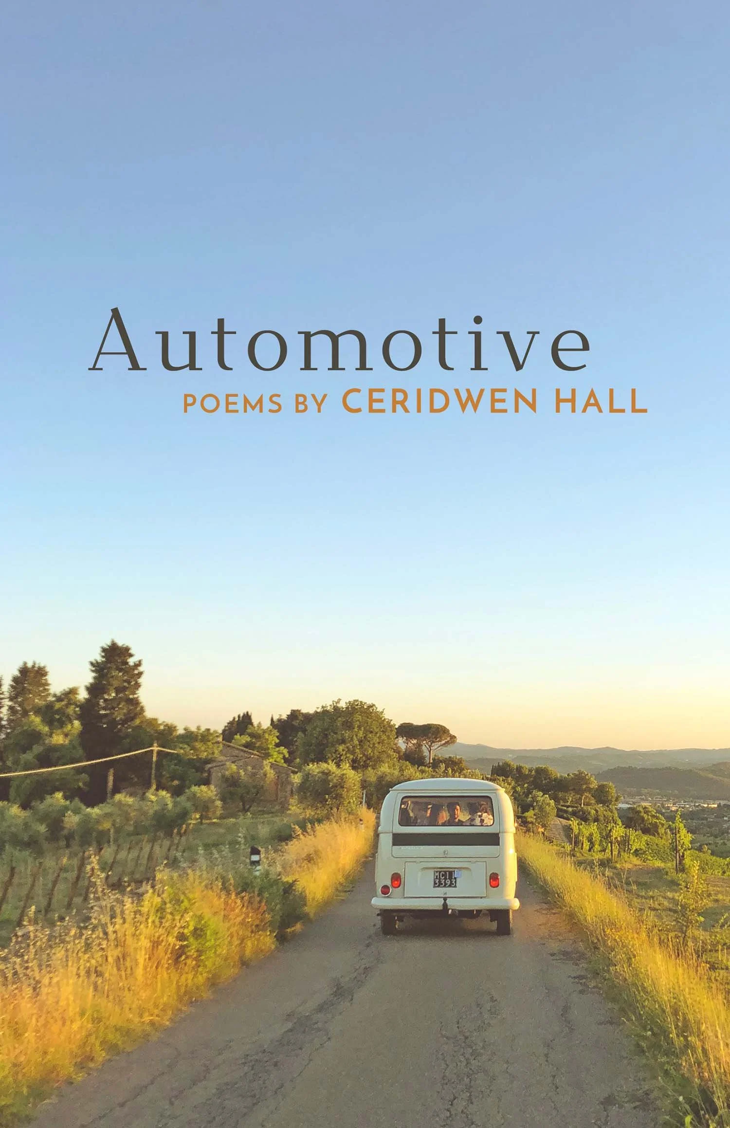 Cover of "Automotive: Poems" by Ceridwen Hall, featuring a vintage van driving on a rural road with fields and hills under a clear sky.