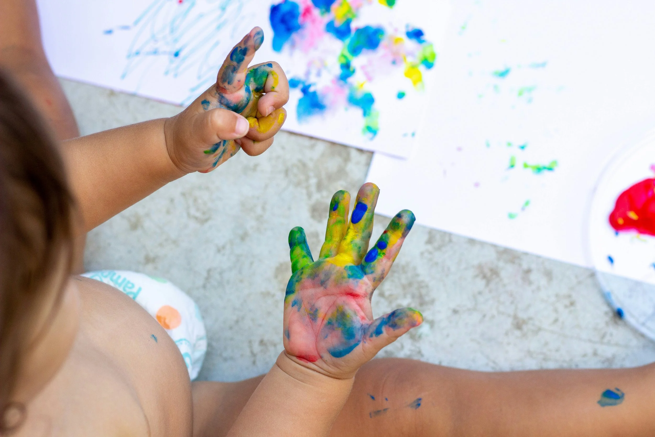 Baby hands in colorful paint