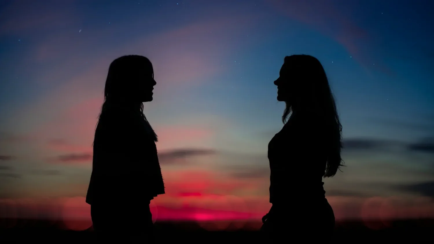 Two people facing one another.