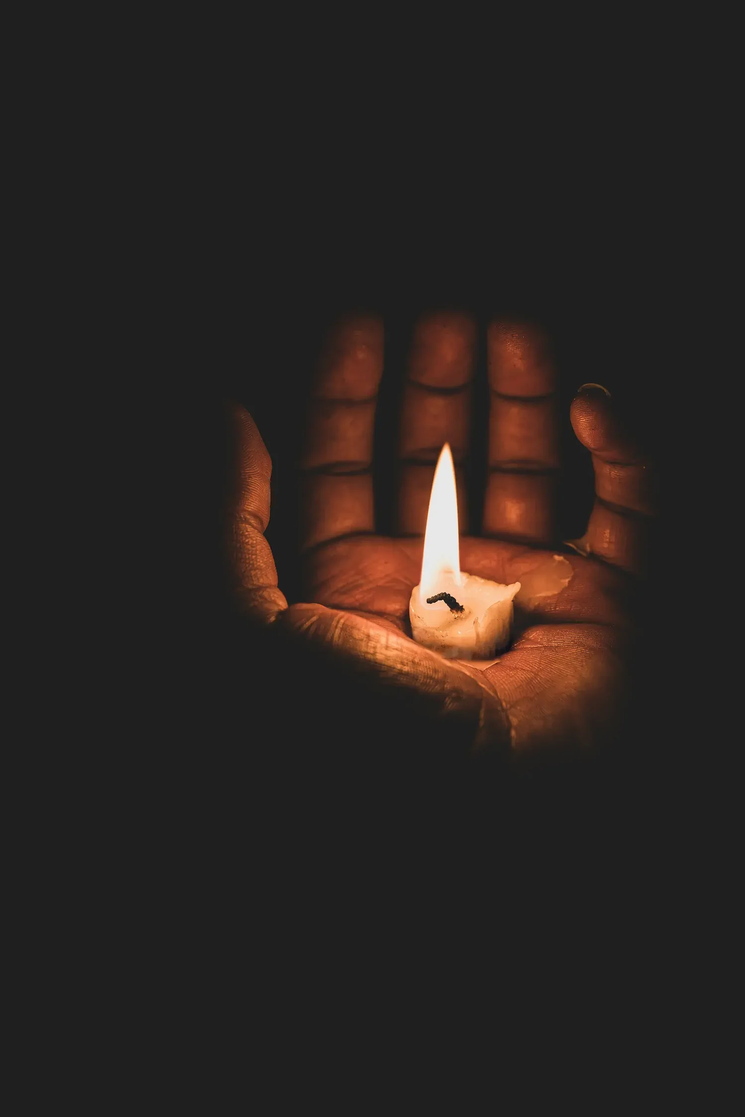 Album cover for Dear Death portraying a hand holding the stub of a light candle.