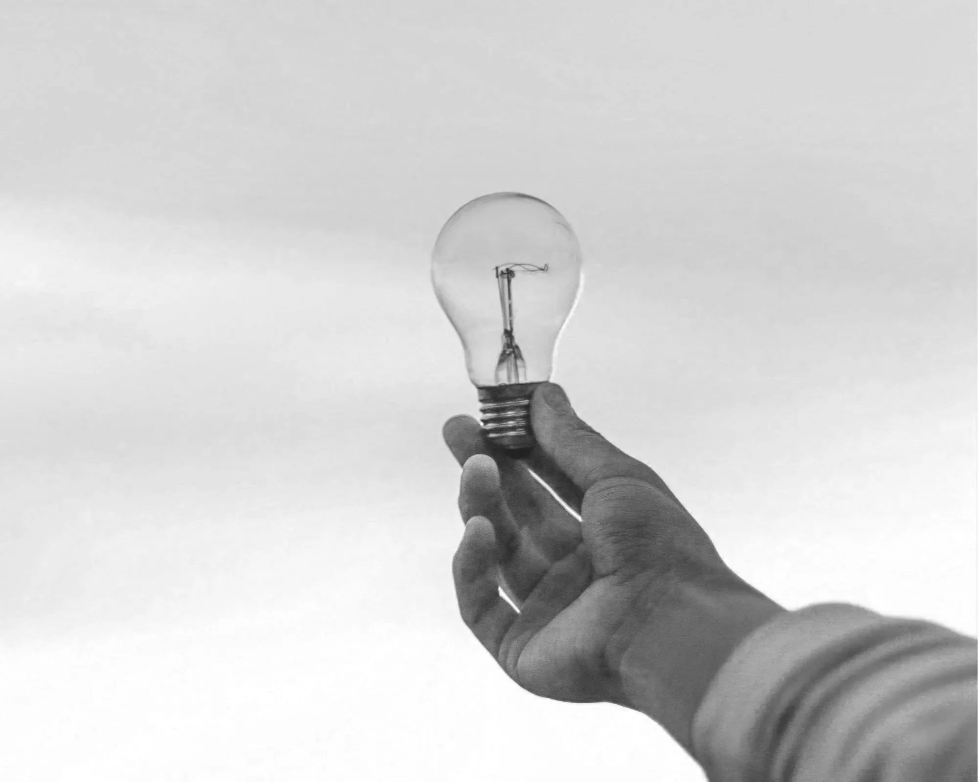 Headshot of smiling male tutor with medium-length black hair wearing a lanyard.