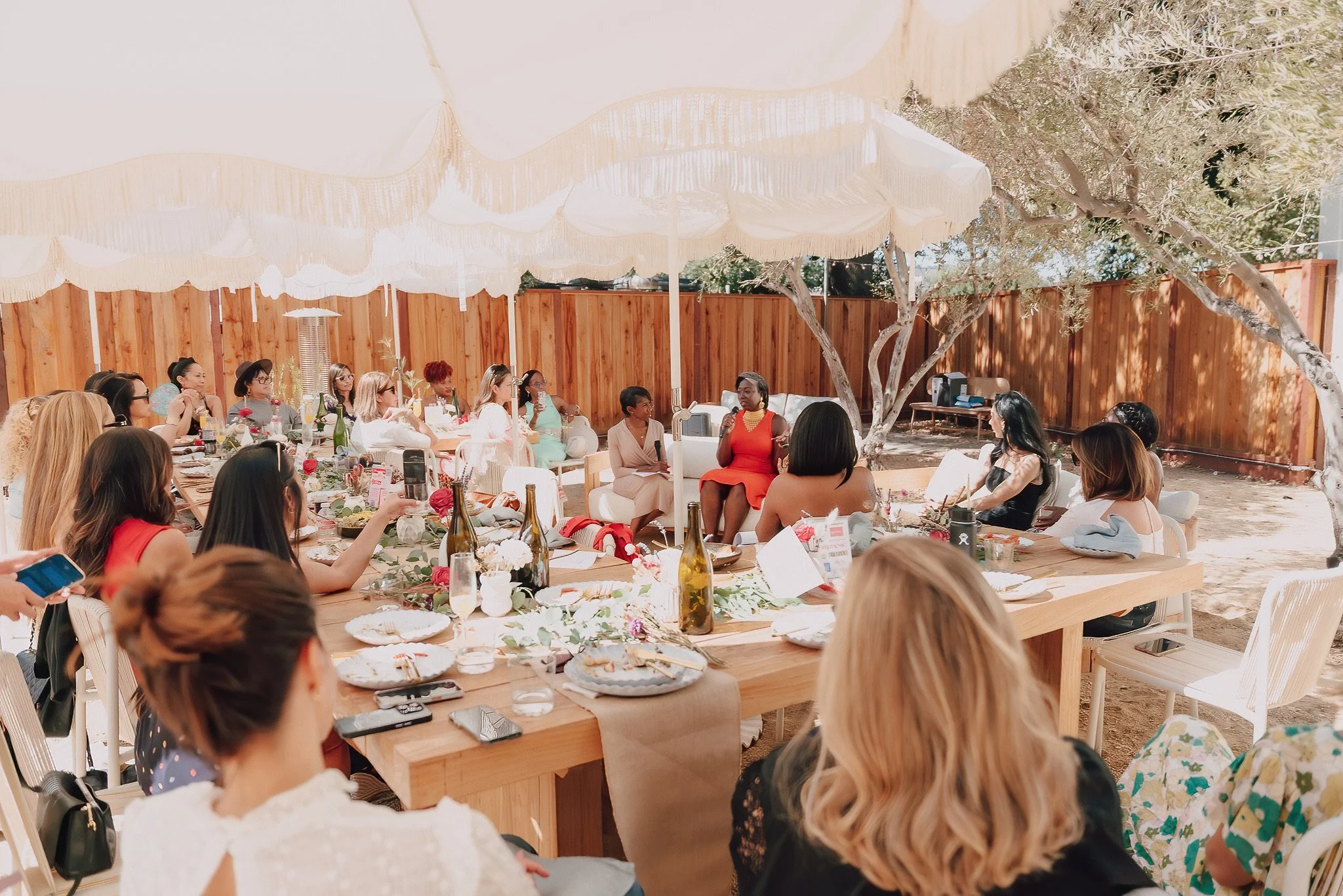 Ladies outdoor brunch listening to speakers at a panel discussion