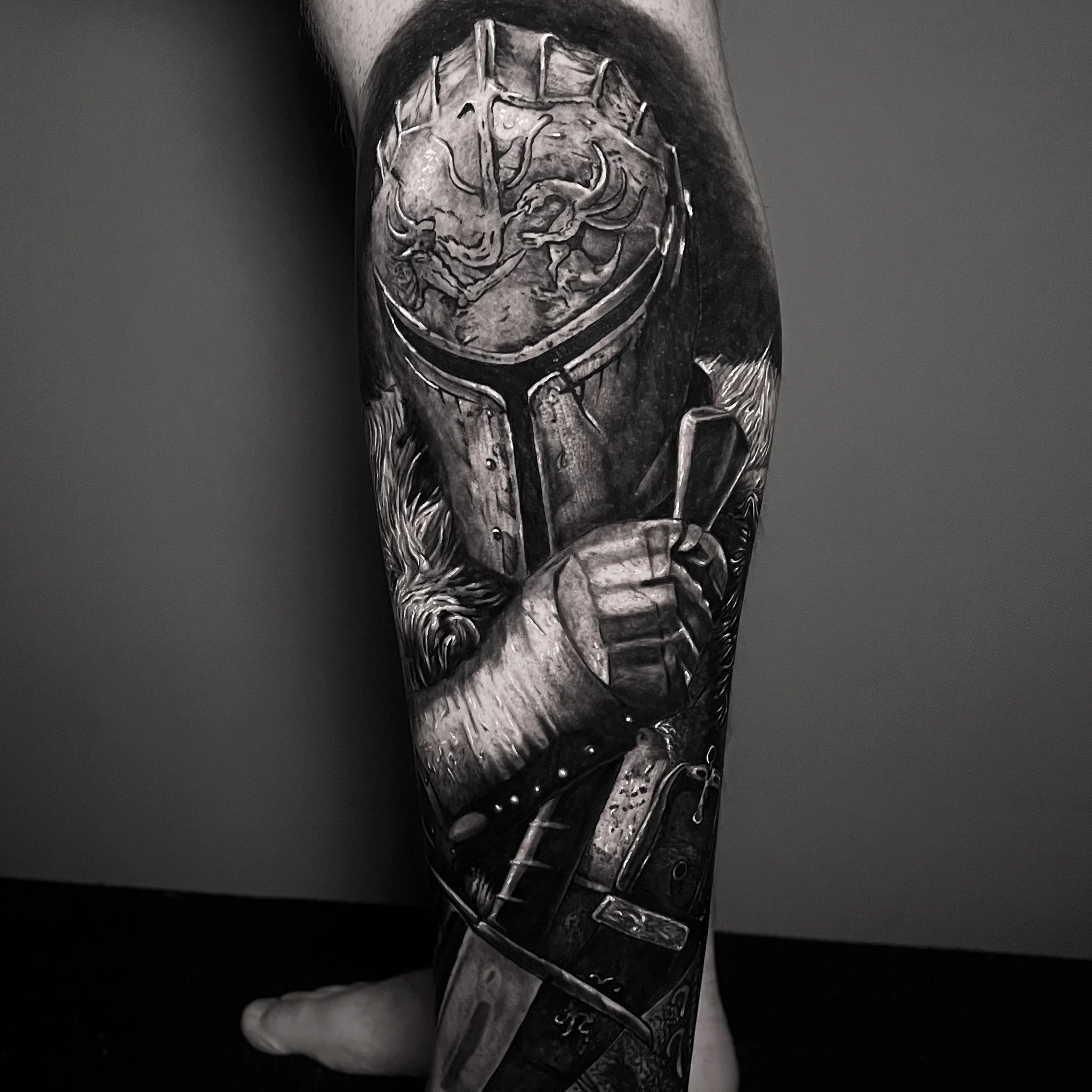 A black and white tattoo of an intricate medieval knight on a person's leg.