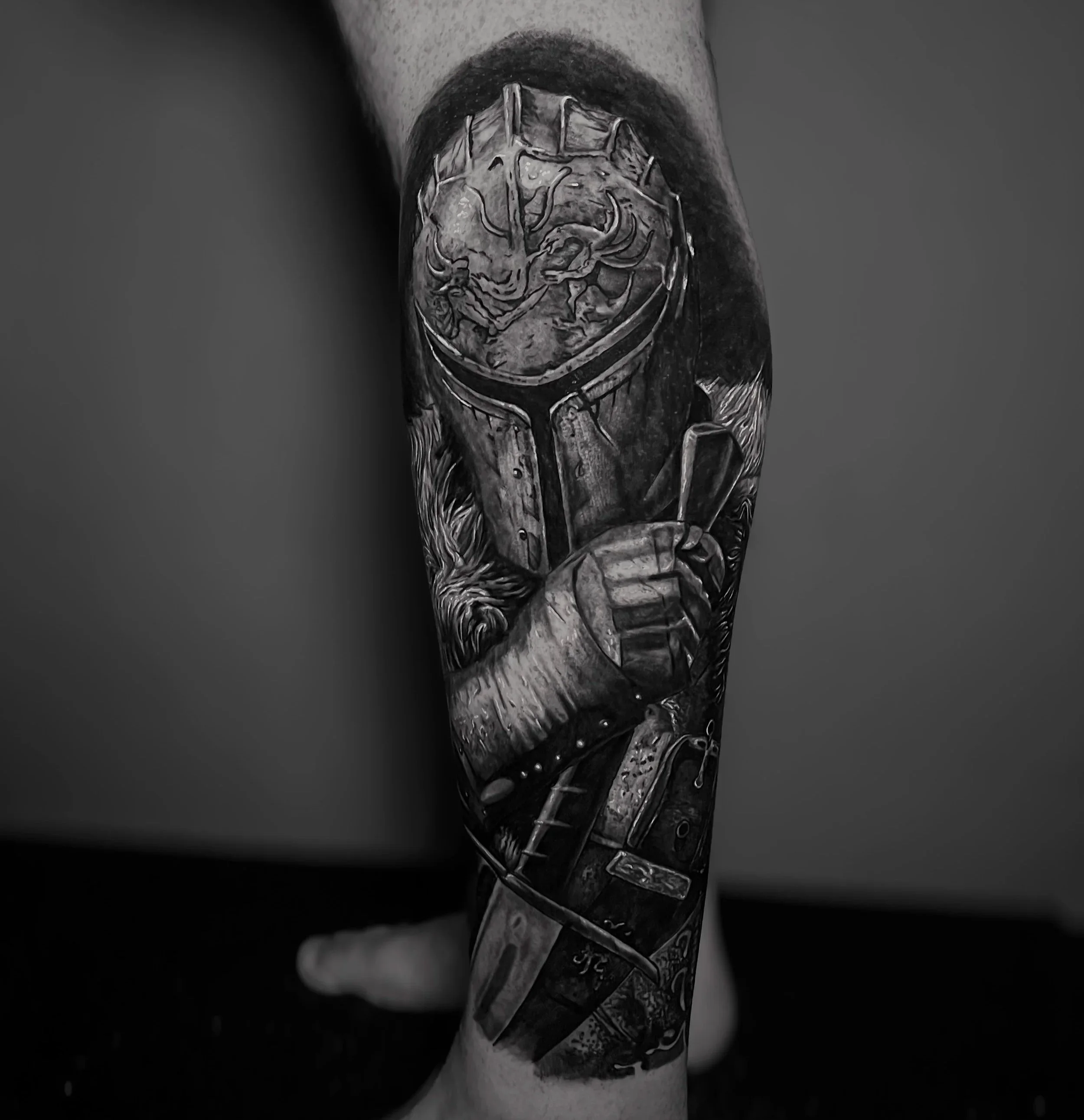 Close-up of a tattoo on a person's leg depicting a detailed image of a knight, rendered in black and grey ink.