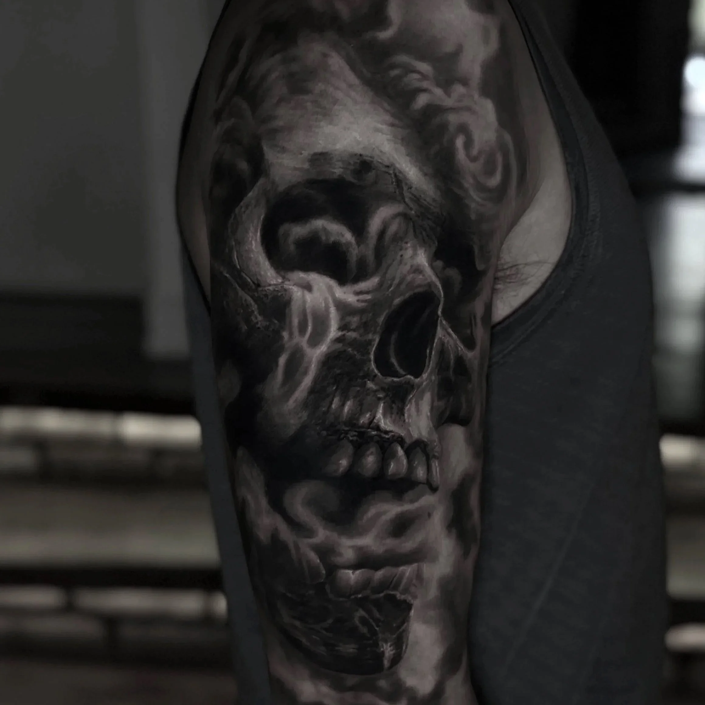 Close-up of a skull tattoo on a person's arm.