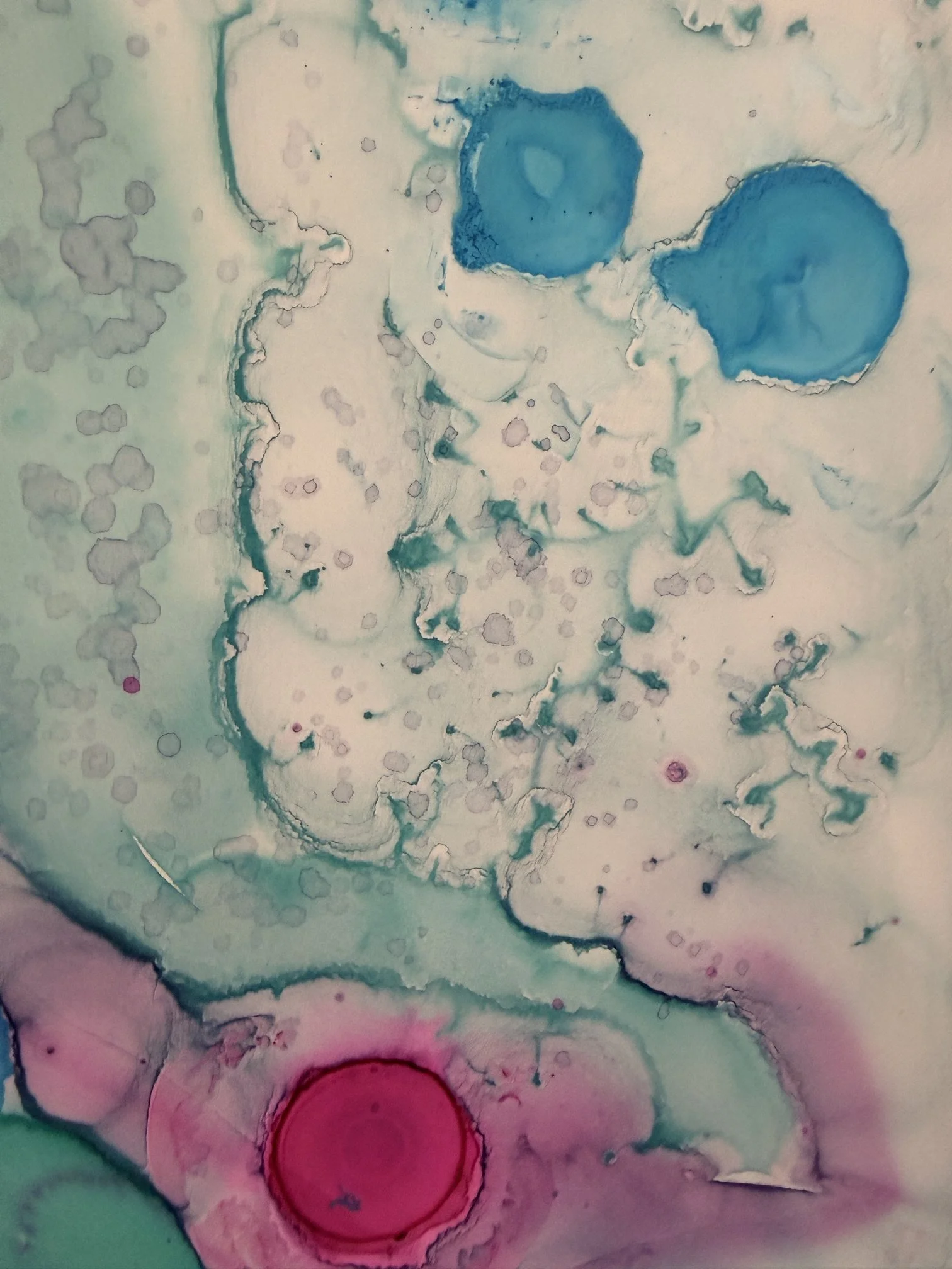 An abstract watercolor painting with light pastel colors, including blue, pink, and purple, featuring circular and irregular shapes and patterns.