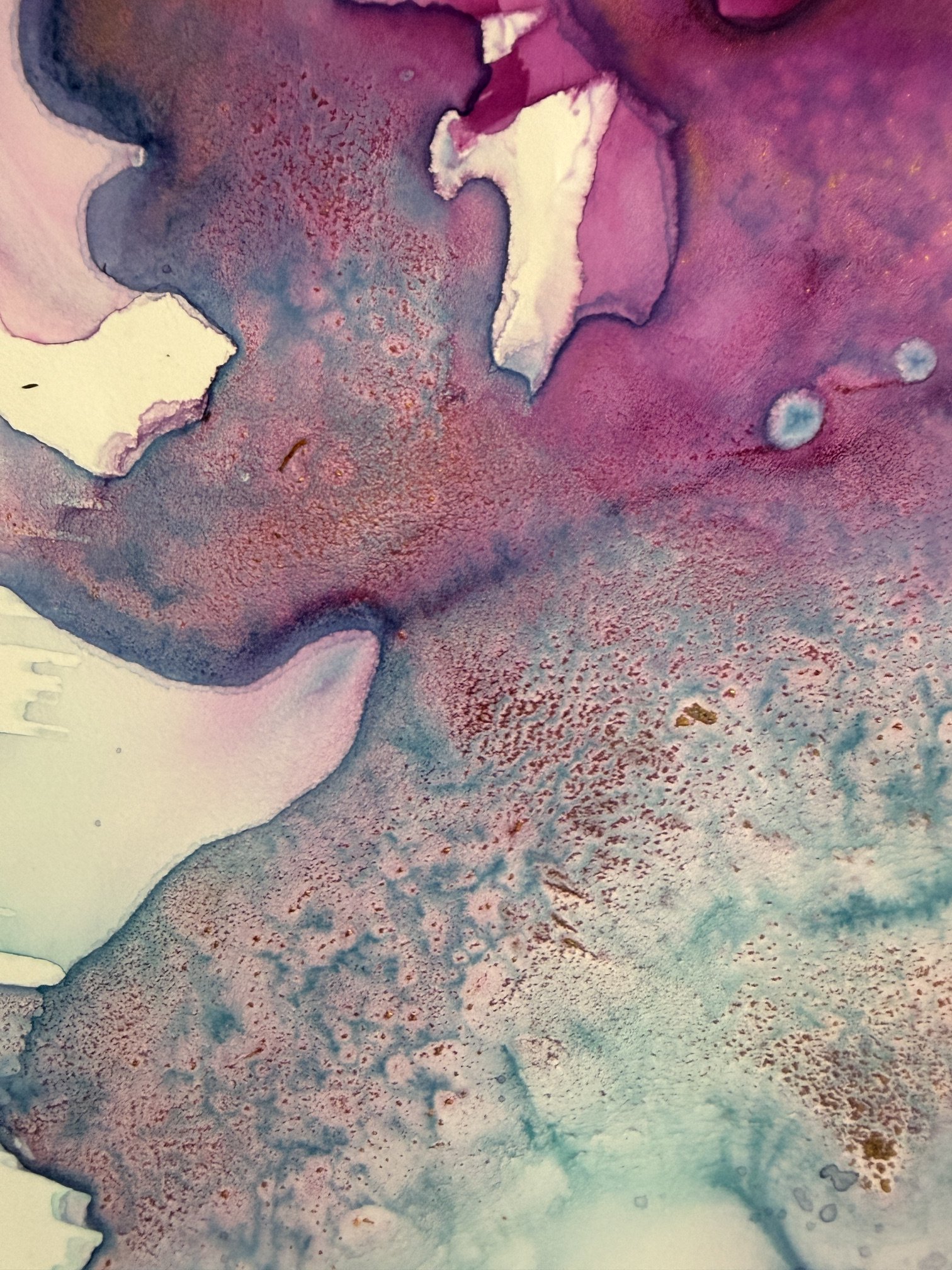 Abstract watercolor painting featuring shades of purple, pink, blue, and hints of gold and white, with textured and flowing patterns.