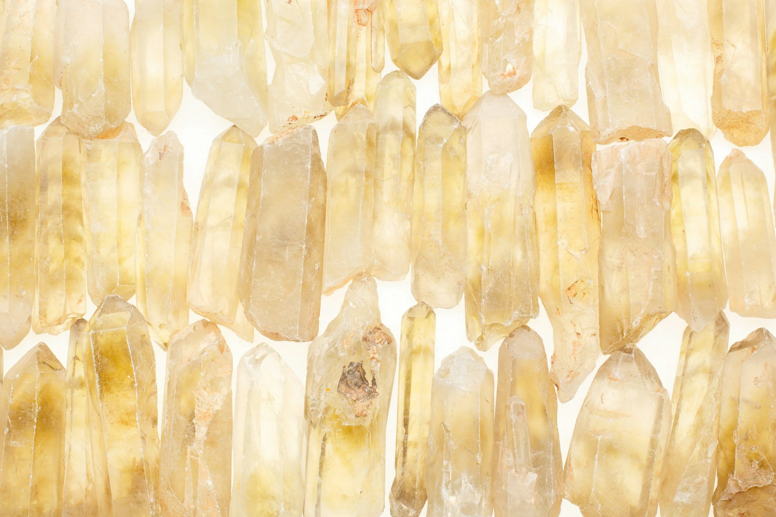 Close-up of yellowish crystal quartz stones hanging in a chandelier