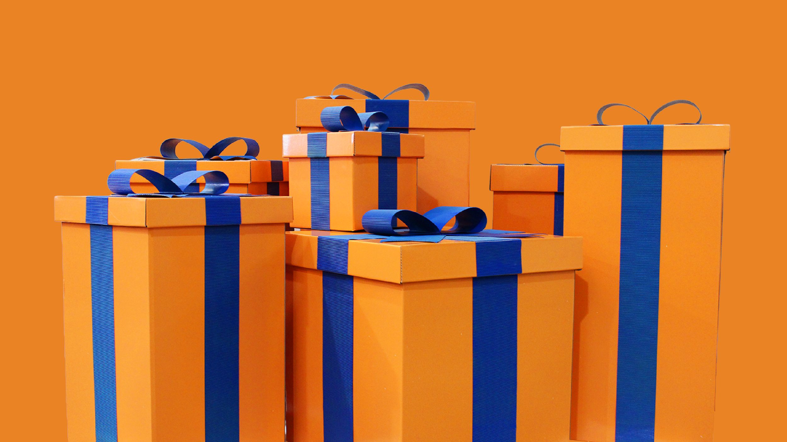 Orange gift boxes with blue ribbons and bows against an orange background.