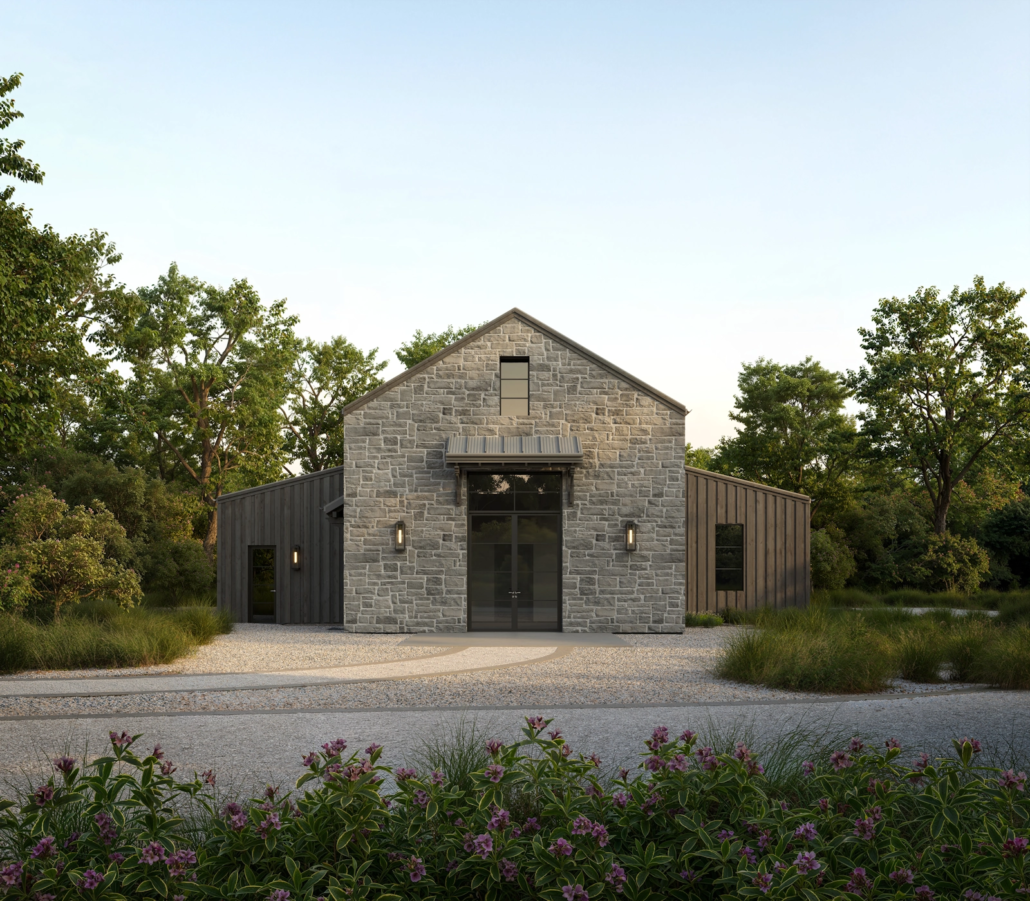 A modern house with stone and metal siding, surrounded by trees and landscaped bushes, with a gravel driveway leading to the entrance.