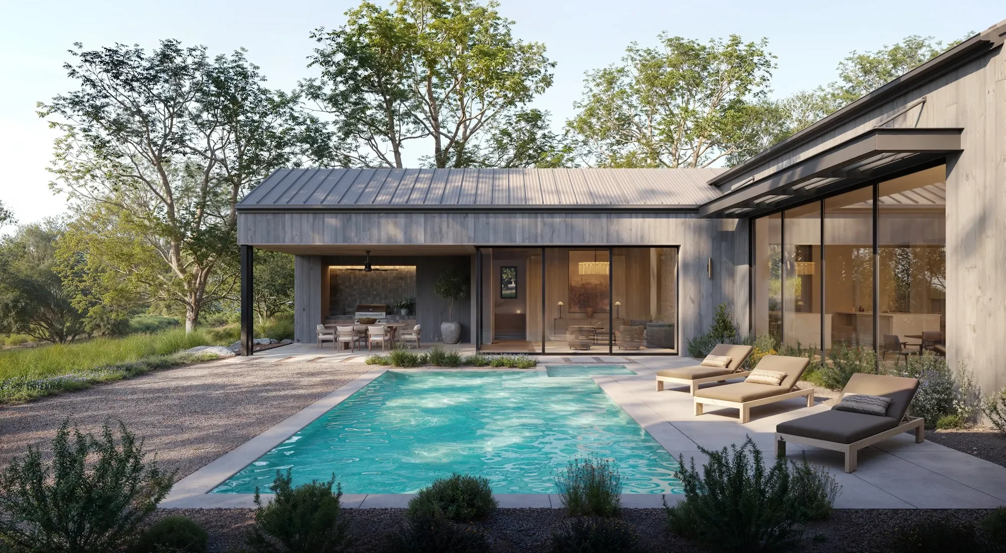 Modern house with large glass windows, outdoor pool, patio seating area, and surrounded by tall trees and greenery.