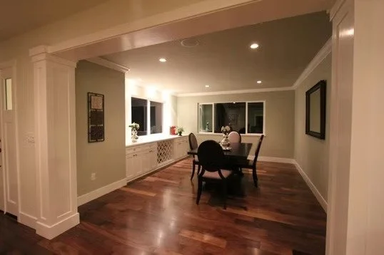 Dining room with a round table and four chairs, windows, and ceiling lights, in a modern home.