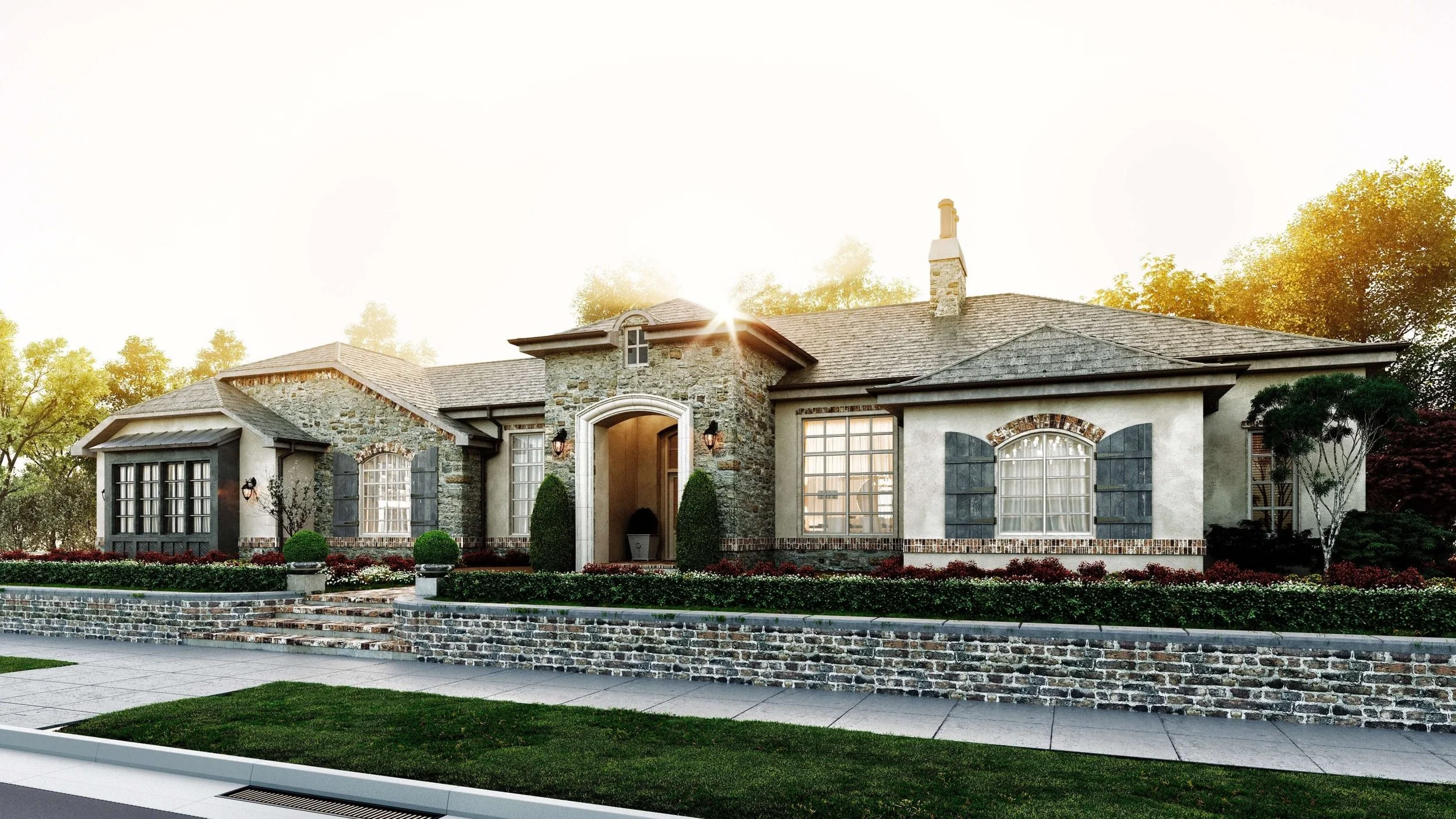Front view of a large house with a stone and stucco exterior, multiple windows with shutters, a brick staircase leading to the entrance, and surrounded by landscaped greenery, trees, and flowers.