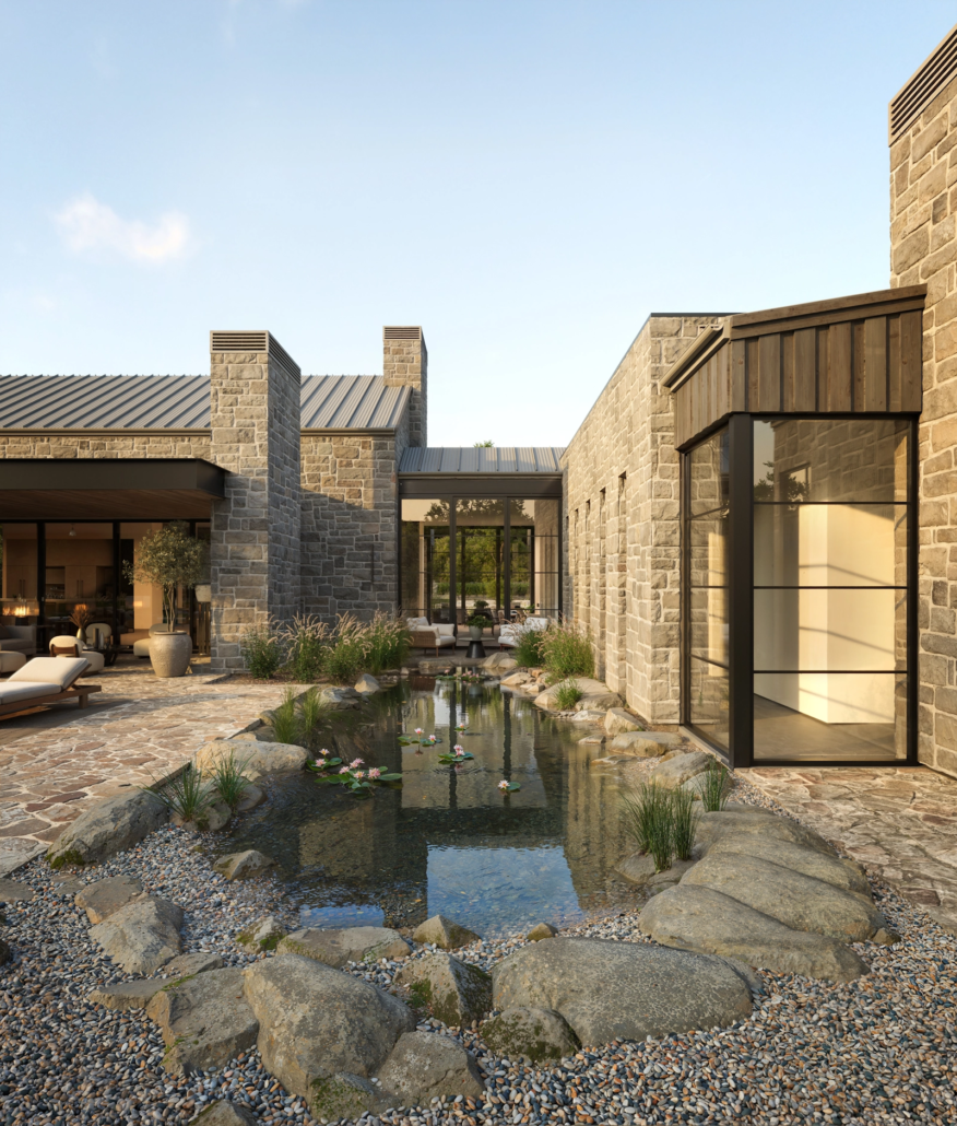 Modern house with stone walls, glass windows, and a small pond surrounded by rocks and plants in a landscaped yard, during daylight.