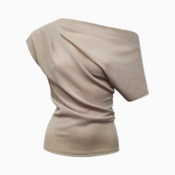 Beige one-shoulder top with draped fabric artfully arranged.
