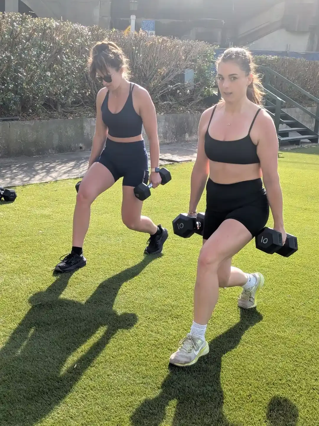 women doing lunges with weights in burn outdoor fitness strength class in milsons point