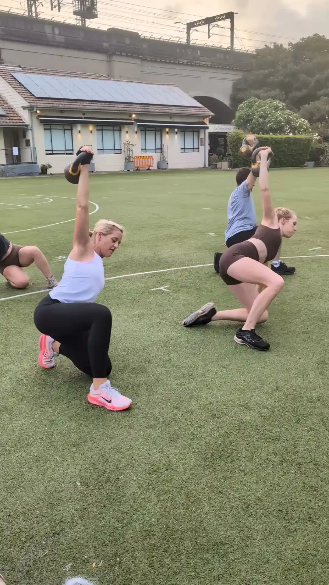 women lifting kettlebells during primal class in the morning at milsons point