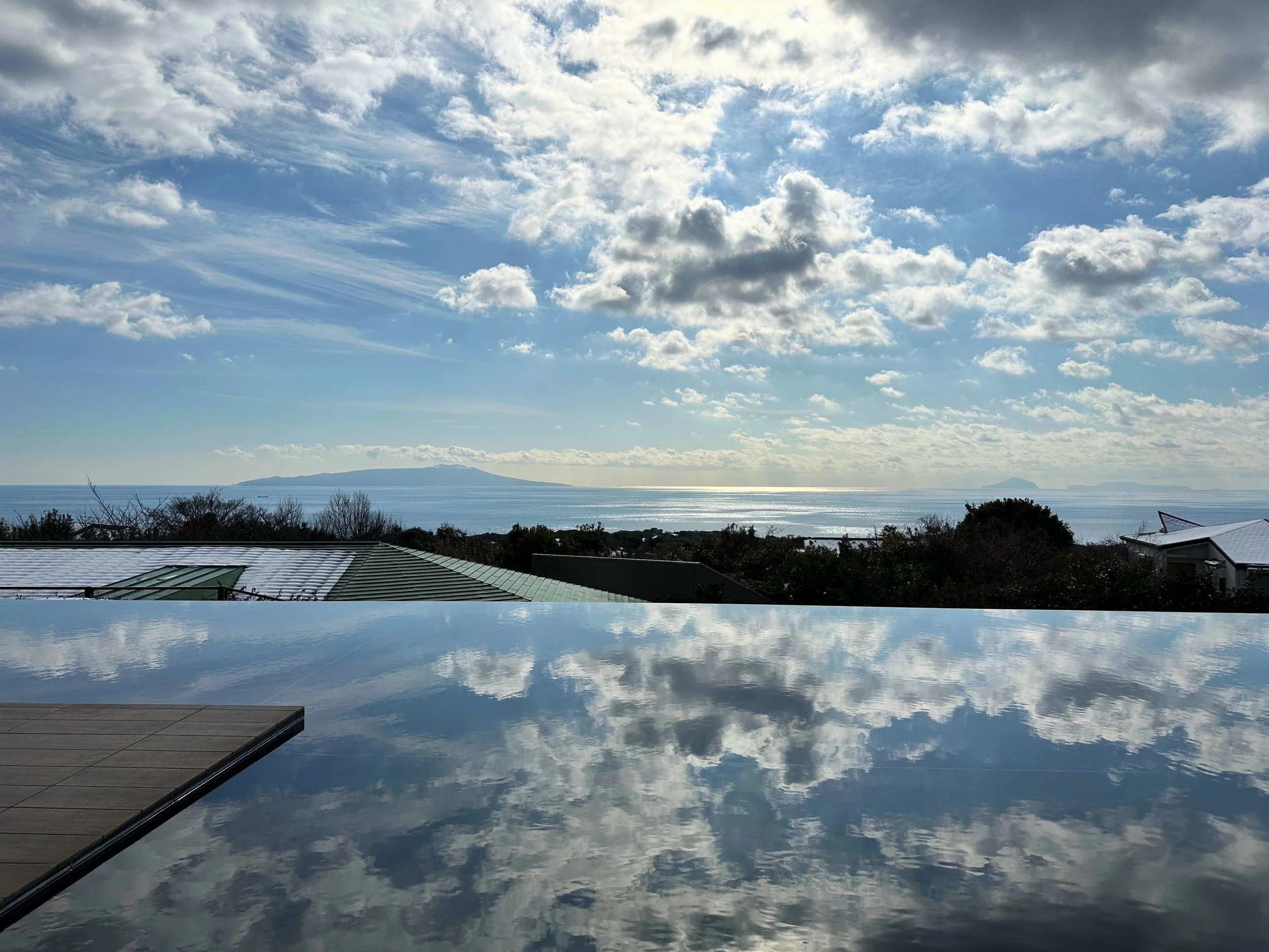 Infinity pool reflecting sky, Kamenoi Hotel Izu Kogen
