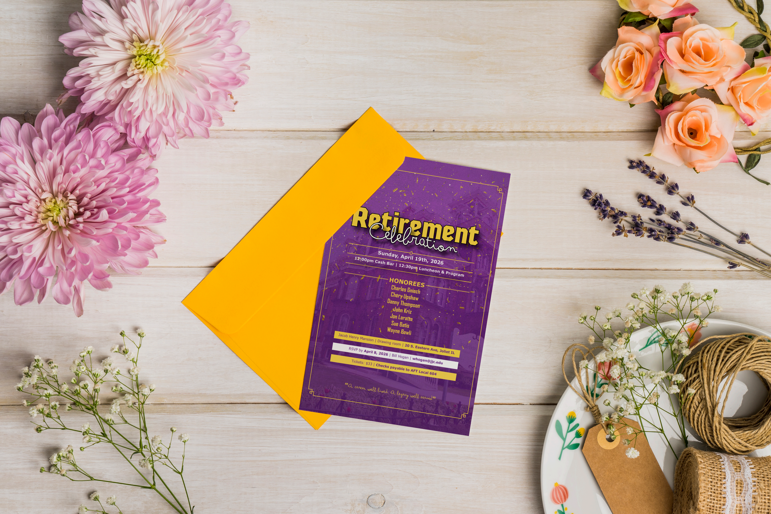 A retirement celebration invitation on a white wooden surface, surrounded by pink and peach flowers, lavender sprigs, and decorations including a wicker basket and a decorated ceramic plate.