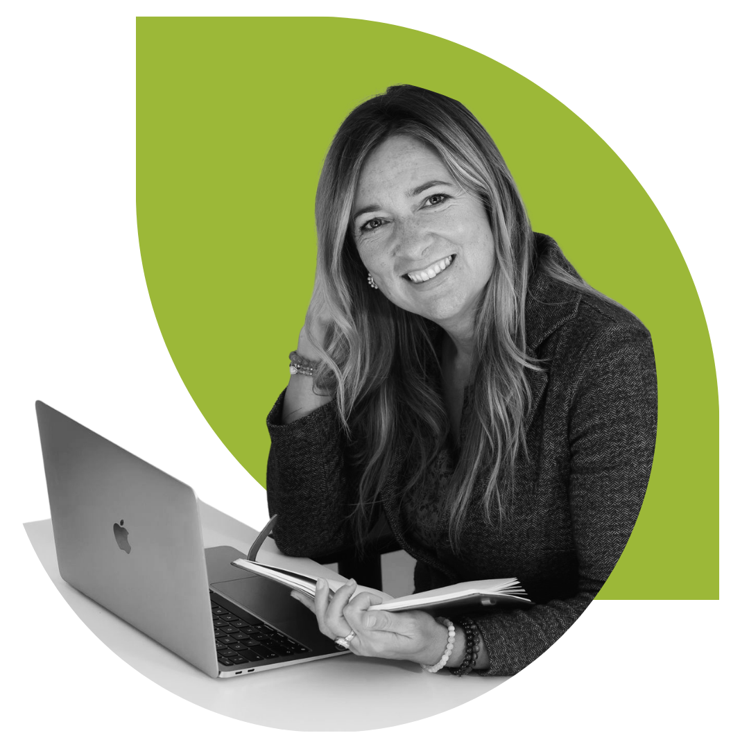 A woman with long hair smiling at the camera, sitting at a desk with an open MacBook laptop and holding an open notebook. The background is green with digital lines.
