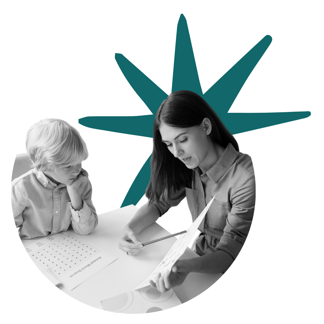 A woman and a young boy sit at a table, looking at a sheet of paper, with the woman holding a pen and pointing to the paper, in a grayscale photograph with colorful geometric shapes in the background.