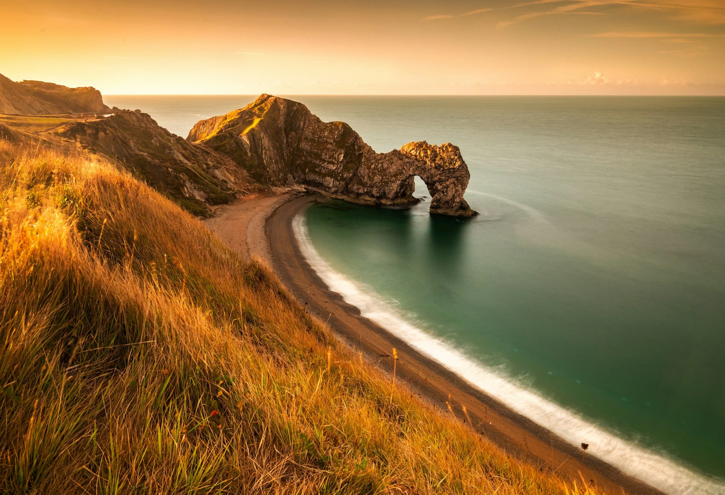 durdle door, beach in dorset with sand and sea