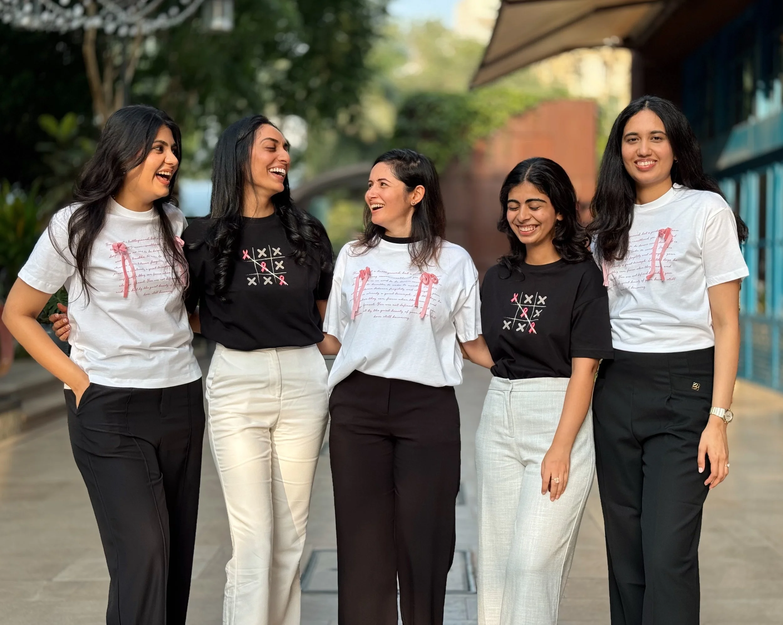 Somaa Health team standing together outdoors, smiling and laughing, wearing Asian Cancer Foundation Merch by The Souled Store.