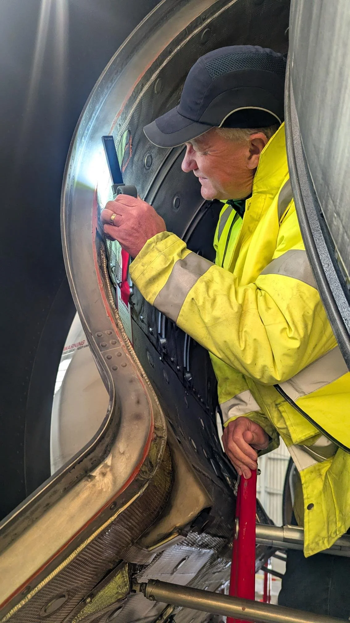 Engineer carrying out aircraft inspection using digital metrology technology