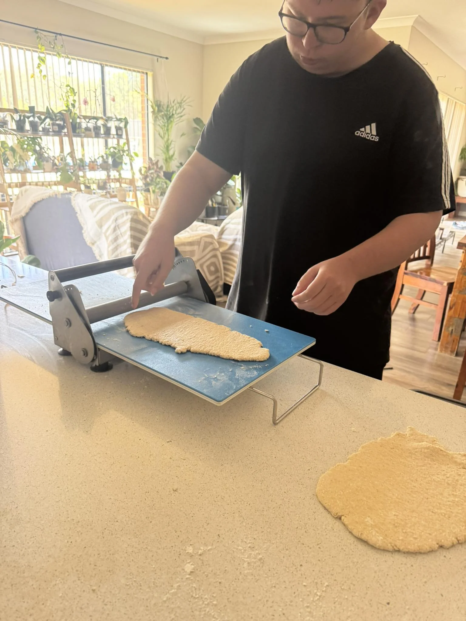 Person cutting dough to make dog treats