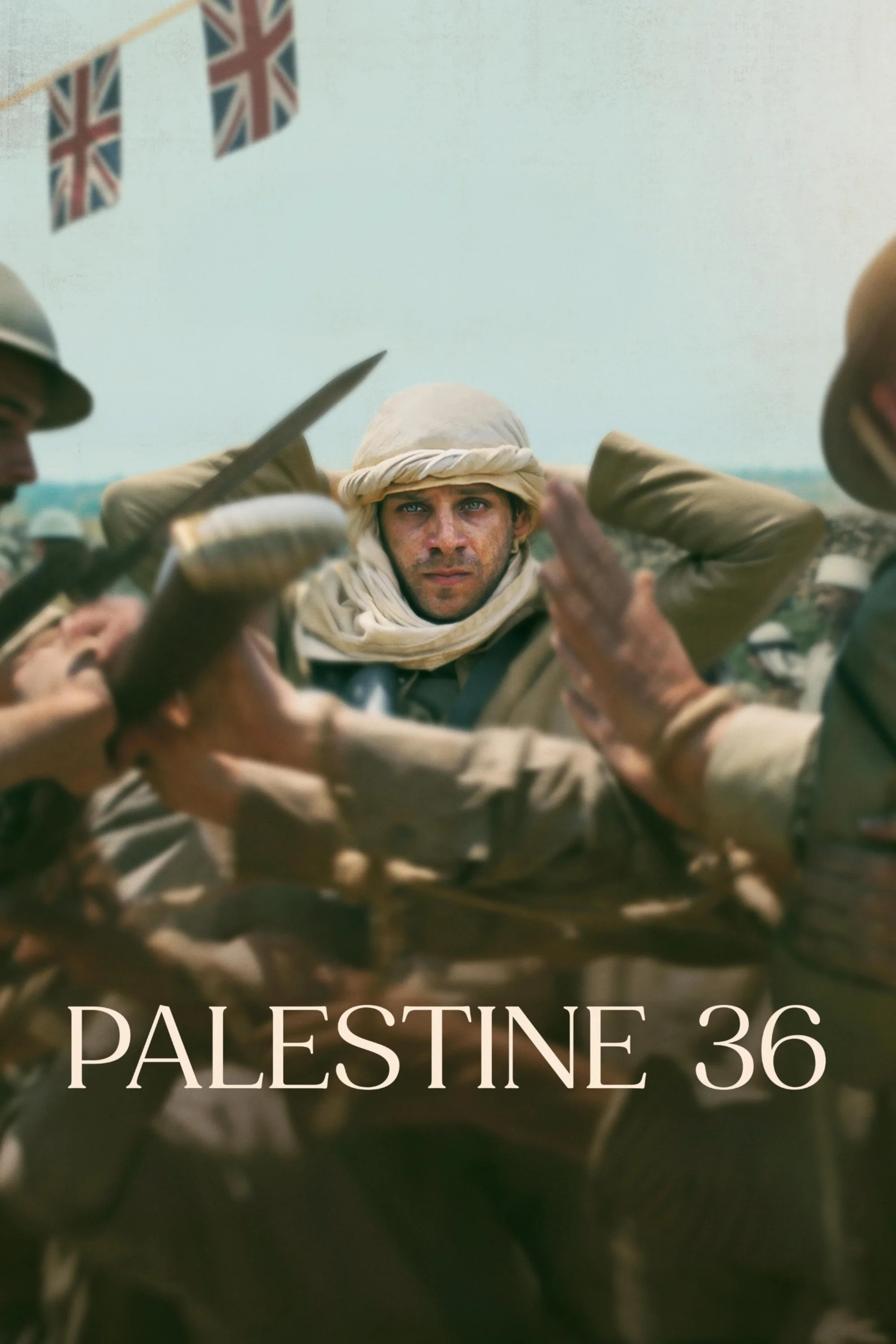 The image shows a group of soldiers with one central soldier in focus, wearing desert camouflage and a headscarf, during a military event in Palestine with a flag in the background. The text on the image reads "PALESTINE 36."